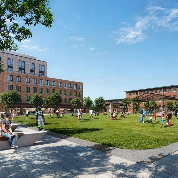 Rendering of open space - green space and hard scape - with people, landscape furniture, a pavilion and brick buildings in the background