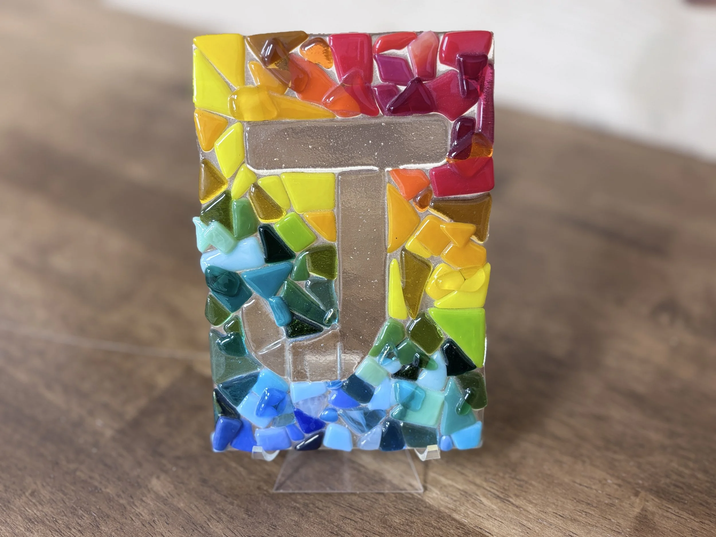Colorful mosaic tiles spelling the word "LOVE" on a white background.