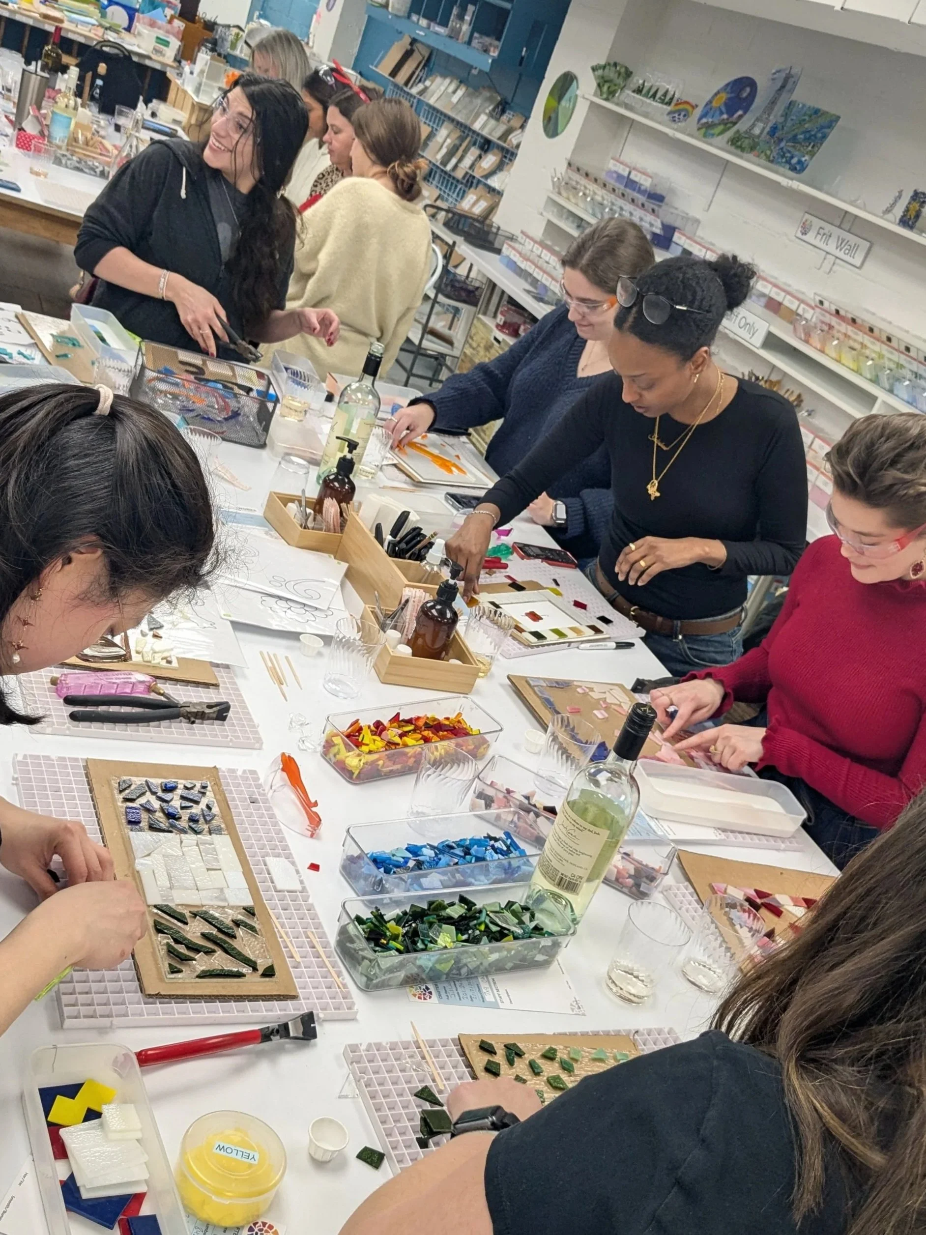 A group of women making fused glass art