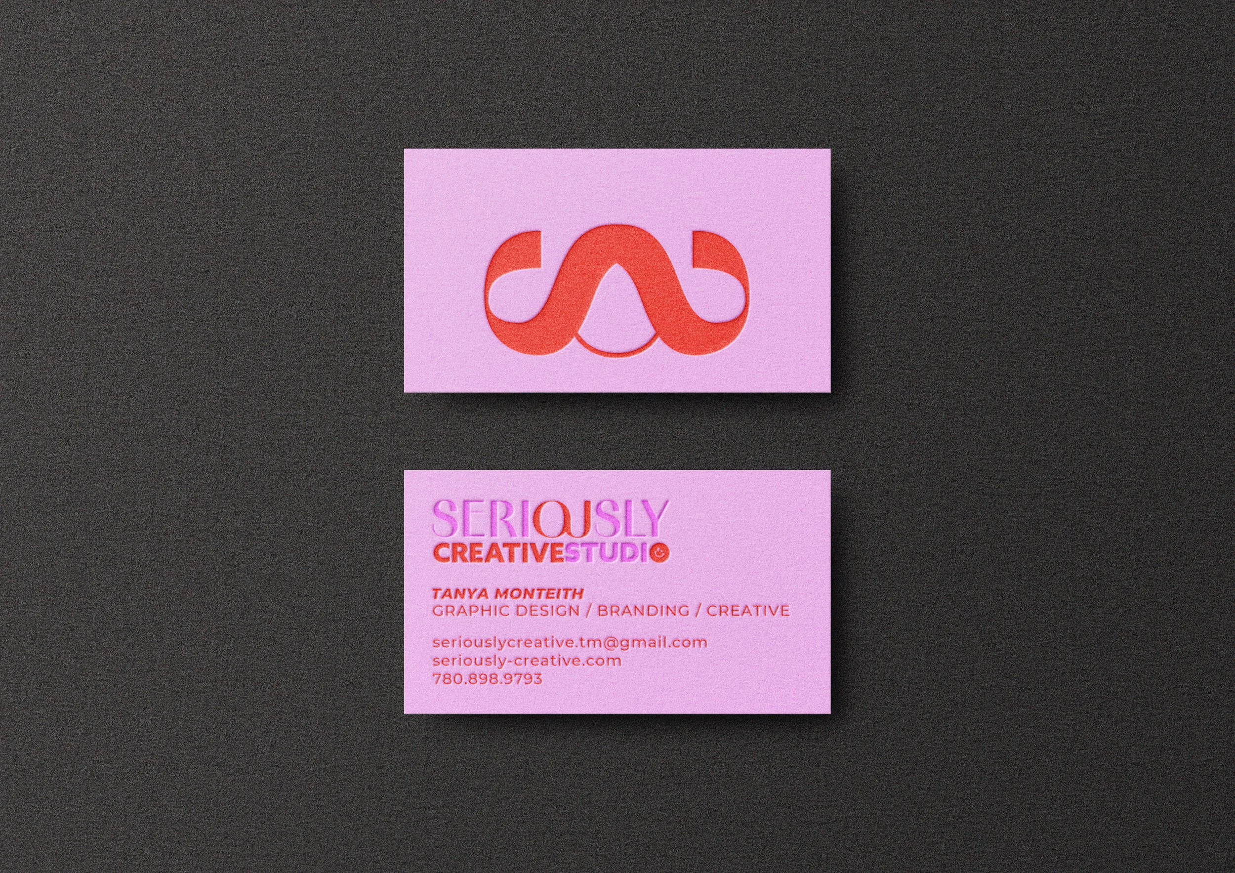 Salmon pink business card with a logo resembling a stylized 'A' in red and pink, and contact information for Tanya Monteith, a graphic designer and branding creative, including email, website, and phone number.
