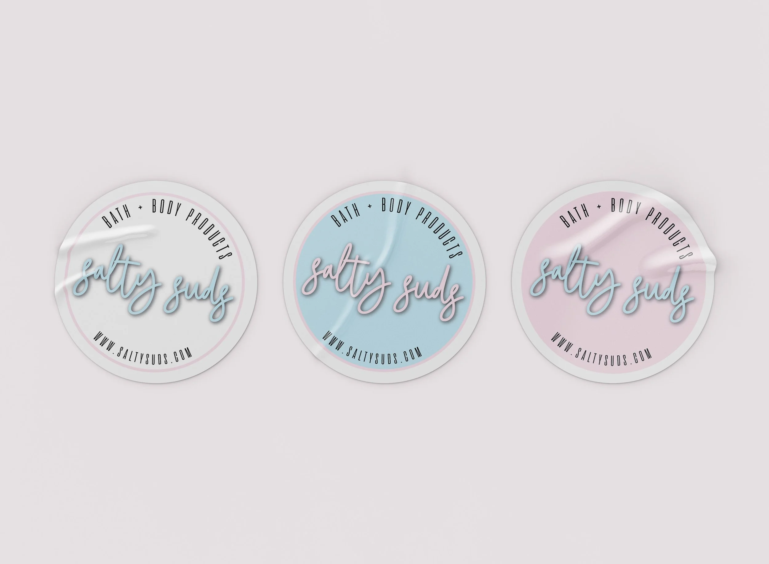 Three circular labels with a pastel-colored background, featuring the words "salty suds" in cursive font, and the website 'www.saltysuds.com' at the bottom.