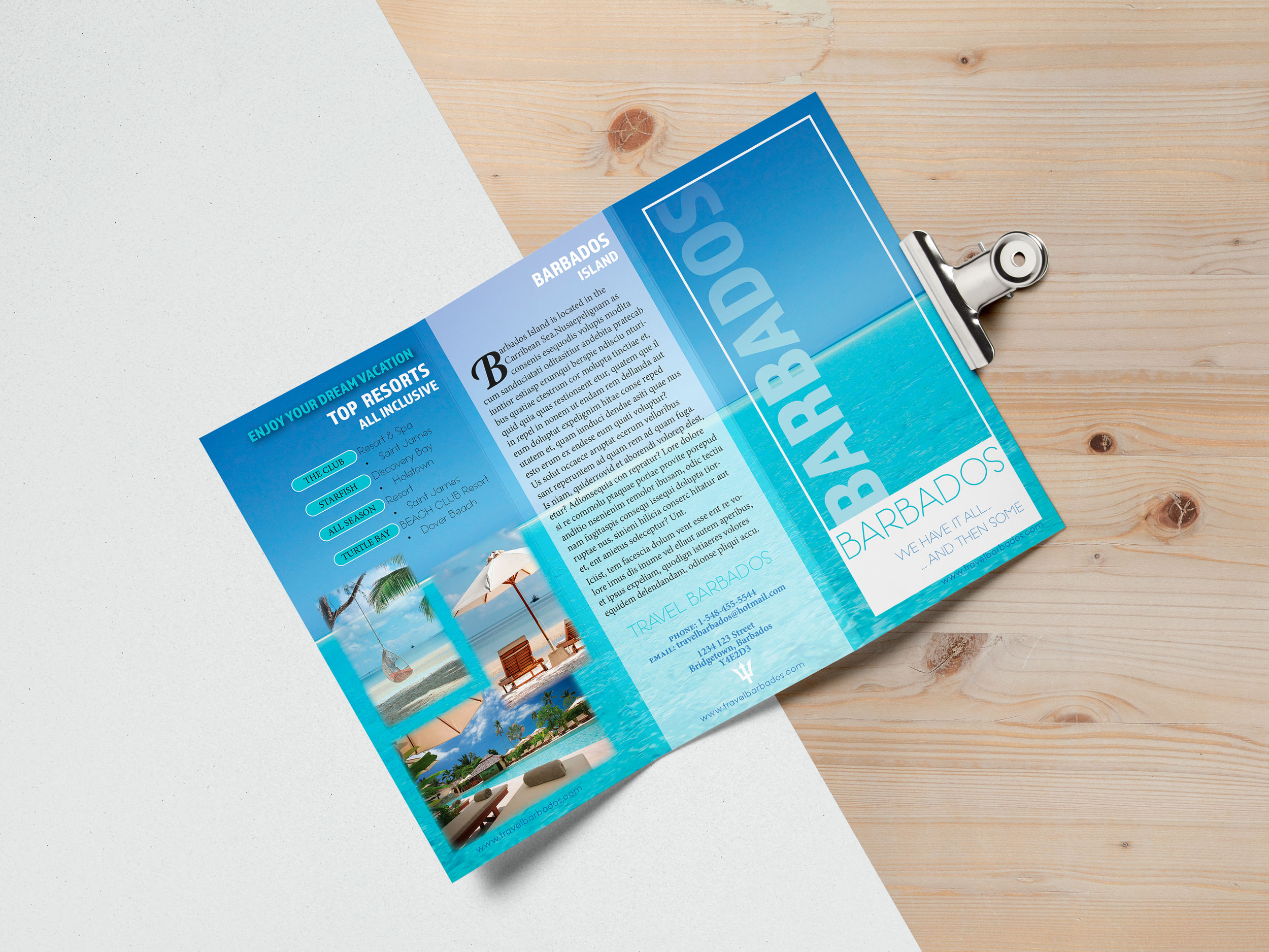 A colorful tourist brochure for Barbados laying on a wooden and white surface, featuring images of beaches, umbrellas, and palm trees, with information about resorts and travel options.