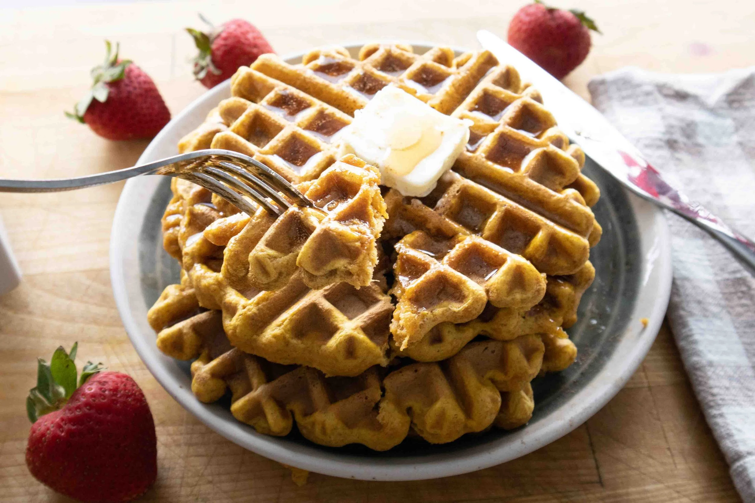 pumpkin spice waffles with butter and syrup
