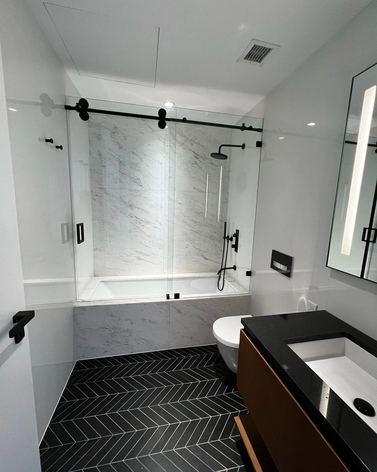 In this apartment, we installed a rolling system shower enclosure in the guest bathroom and all motorized roller shades in the common areas and primary bedroom with decorative linen color drapes to warm up the area. Check it out.
&bull;
&bull;
&bull;