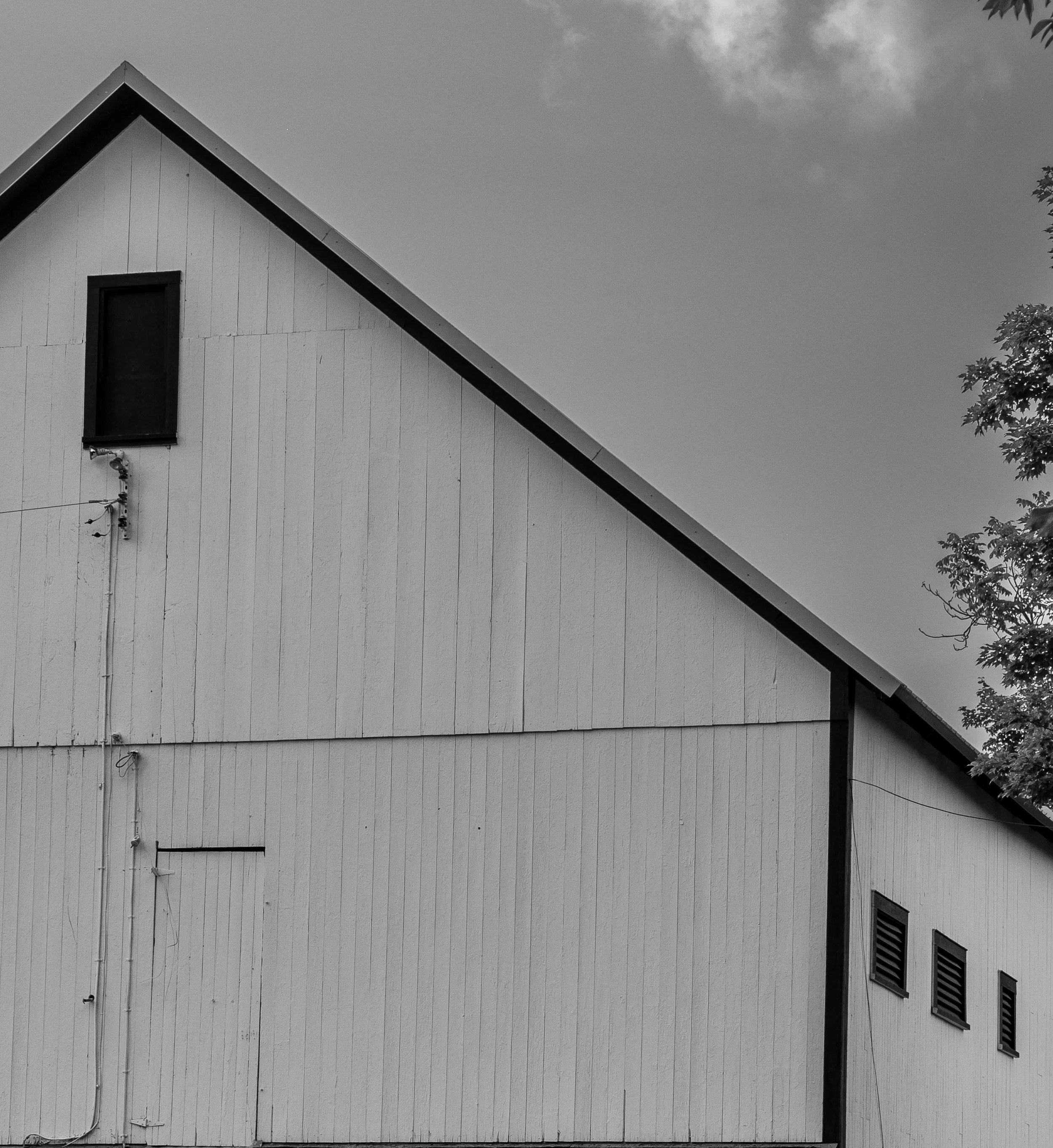 Black and white cropped white barn