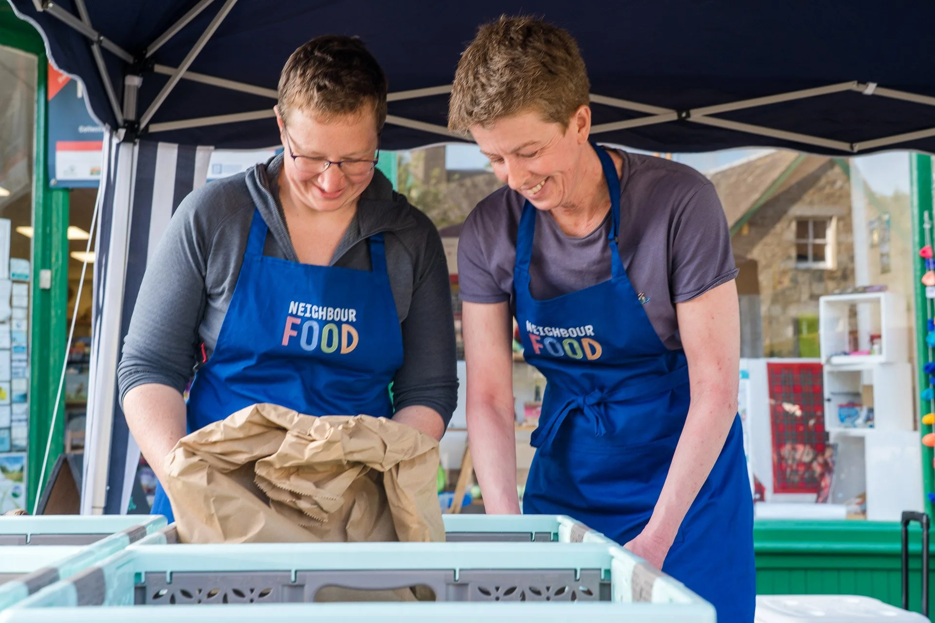 Two members of Neighbour Food on a stall at Killin