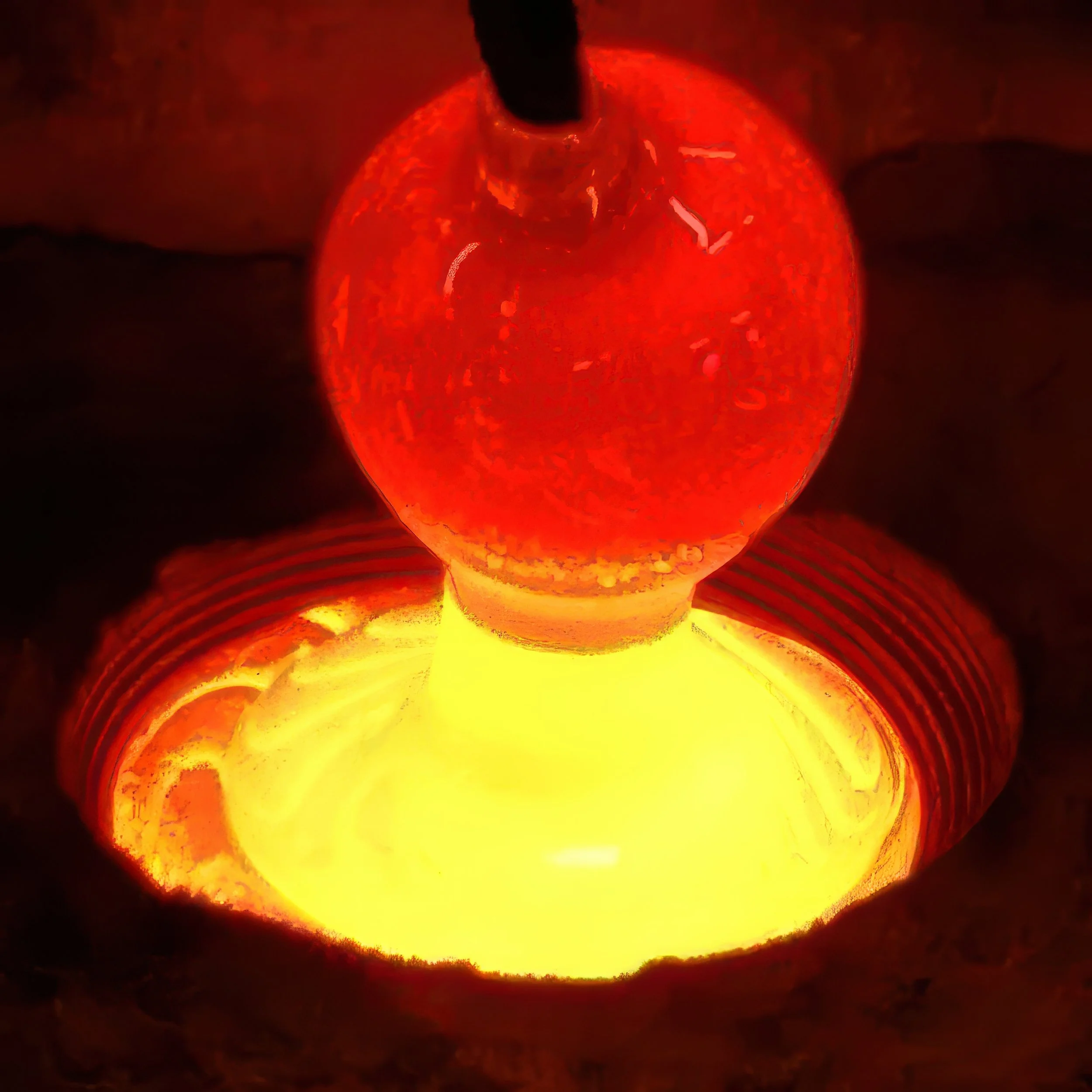 Glass casting process, elaine ford artist pouring molten glass to create glass art