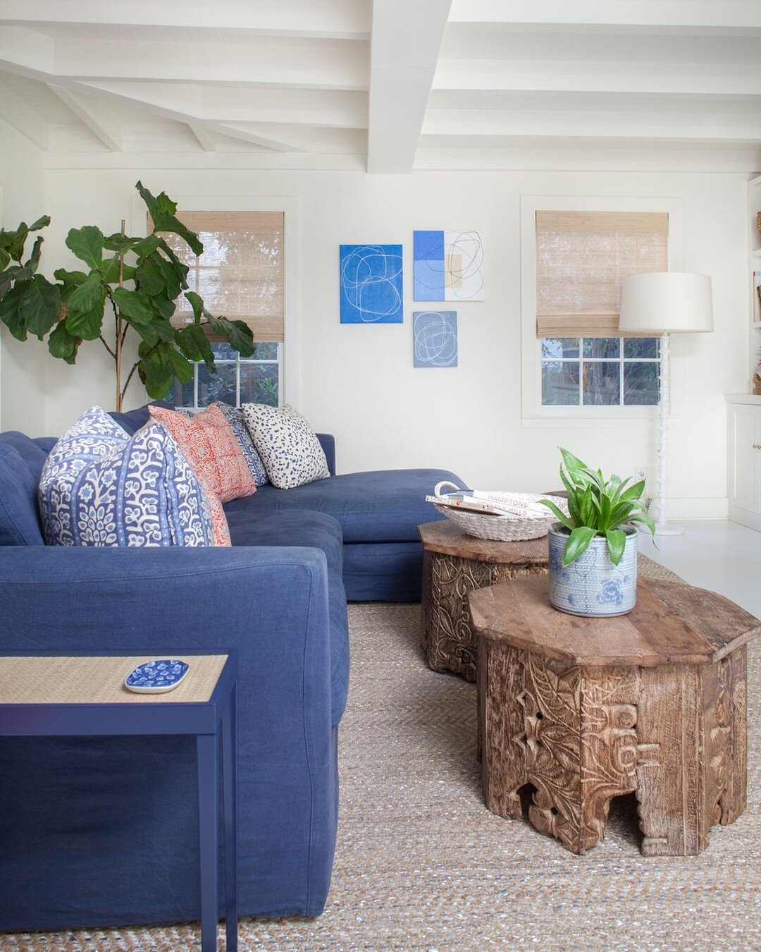 I simply adore this bright and casual beach house family room!

Brought to life through pattern play and anchored with organic elements (such as these gorgeous wood carved accent tables) the natural movement of the space is perfectly suited for its c