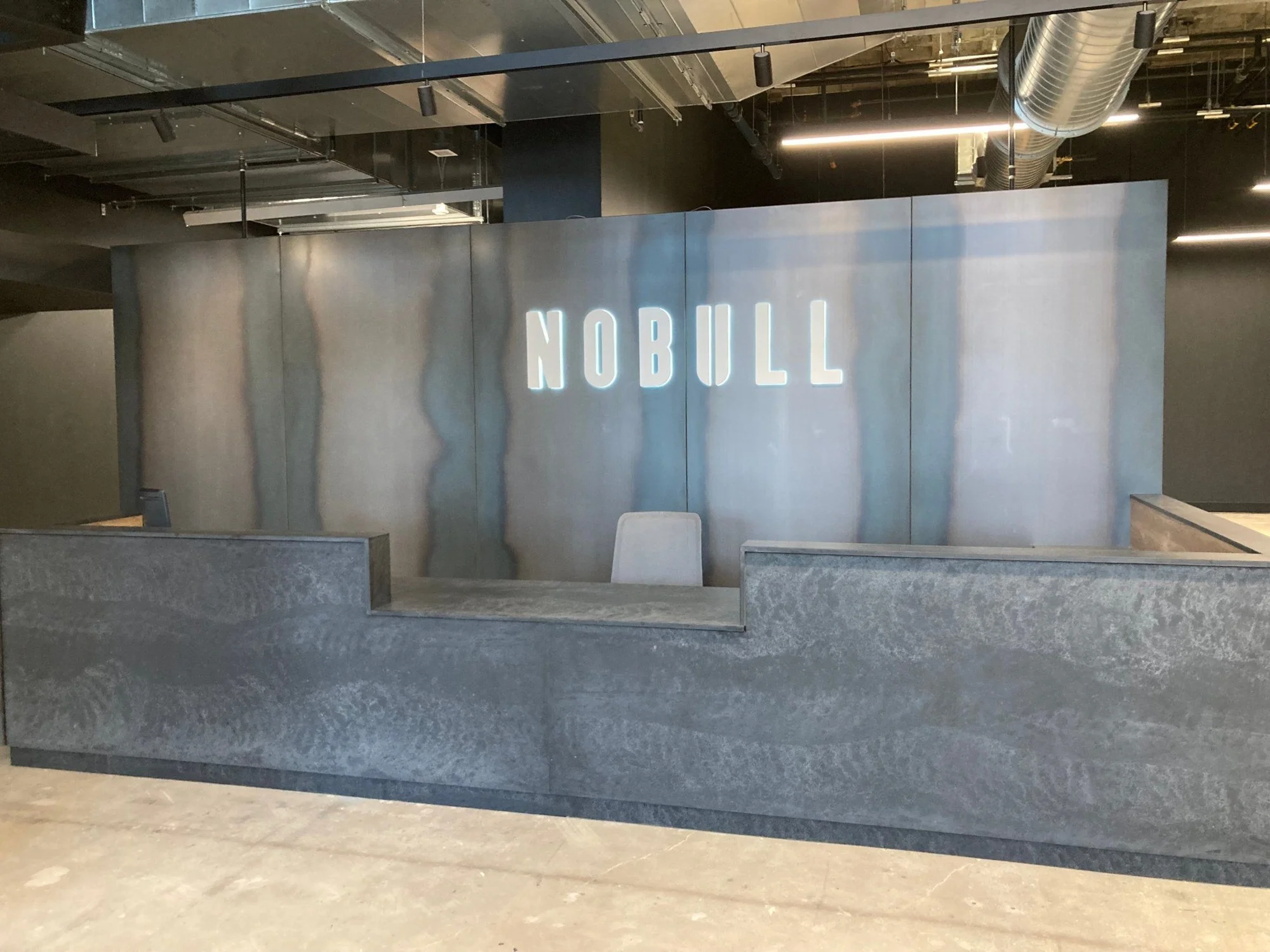 NOBULL HQ — Reception desk & feature wall