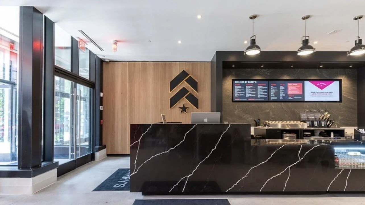 Barry's — Reception desk & wood feature wall
