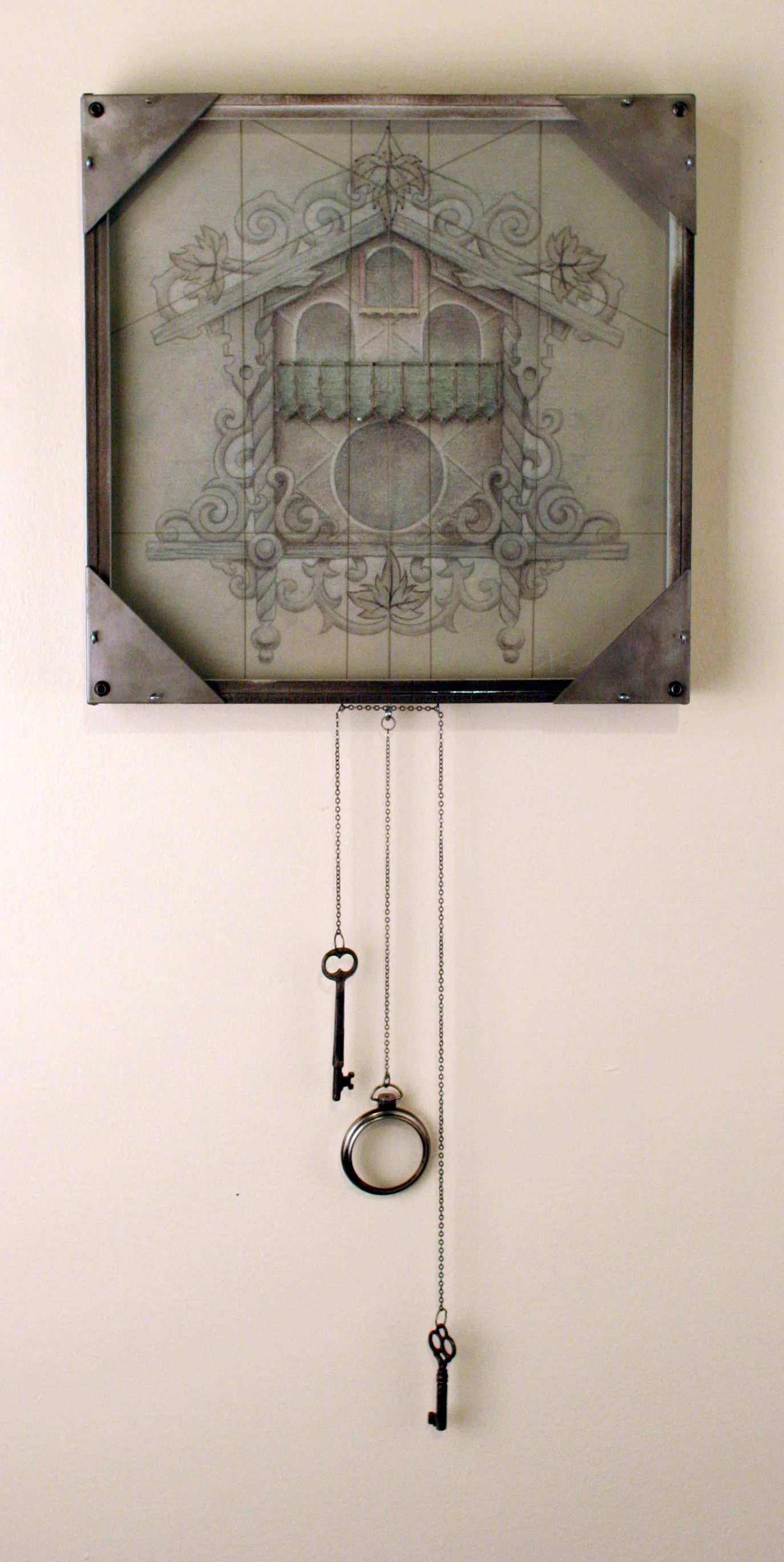 A wall clock with a decorative face featuring a house, scrollwork, and leaves, housed in a metallic frame with hanging keys and rings.