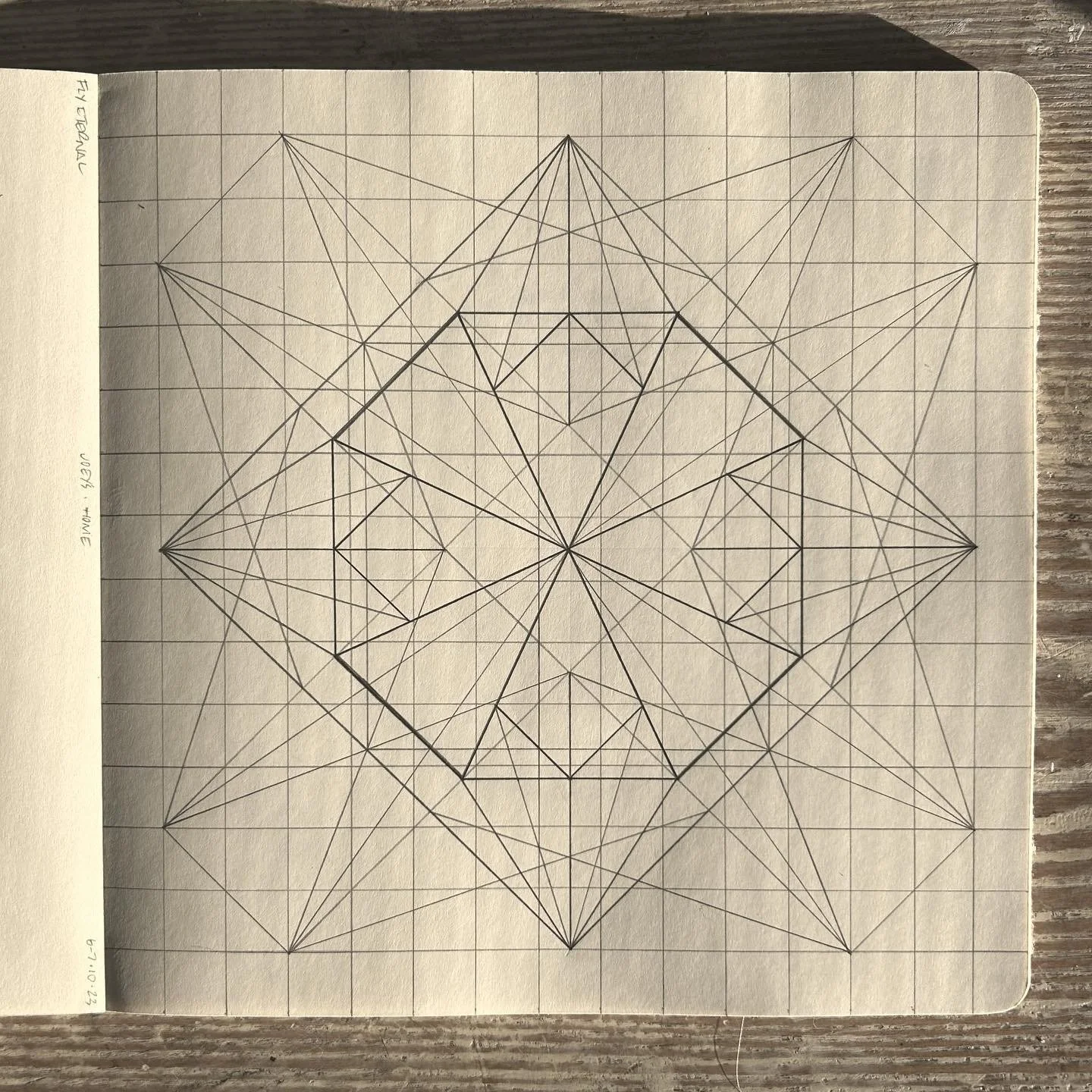 A geometric pattern drawn on graph paper with multiple overlapping lines forming diamonds, triangles, and stars.