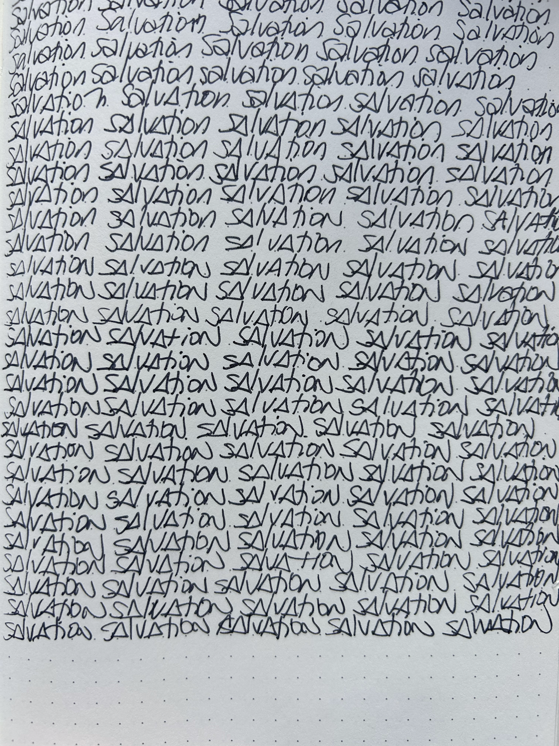 Close-up image of handwriting repeatedly writing the word 'salvation' in cursive.