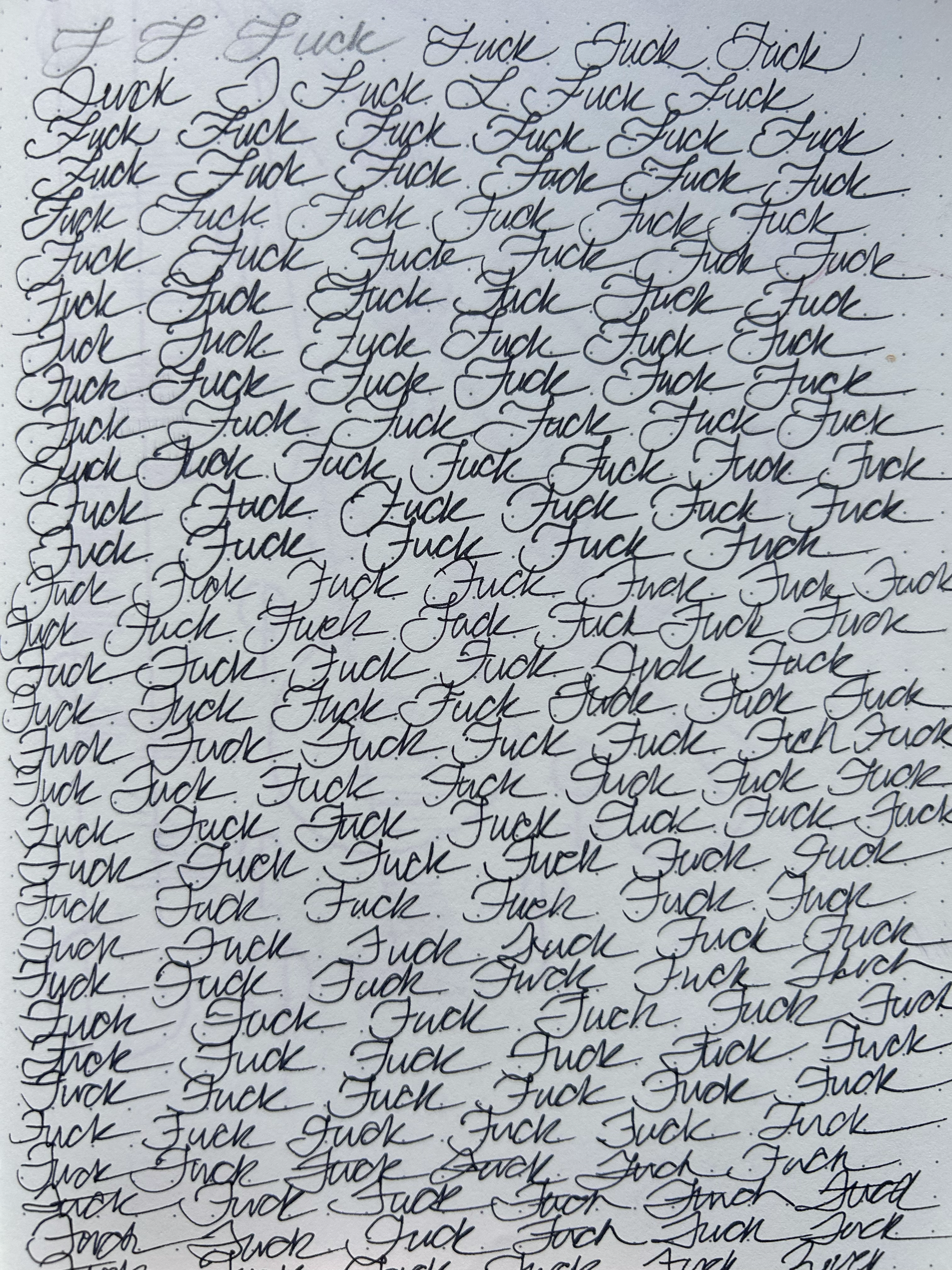 Repeated cursive handwriting of the word 'Fuck' on a piece of paper.