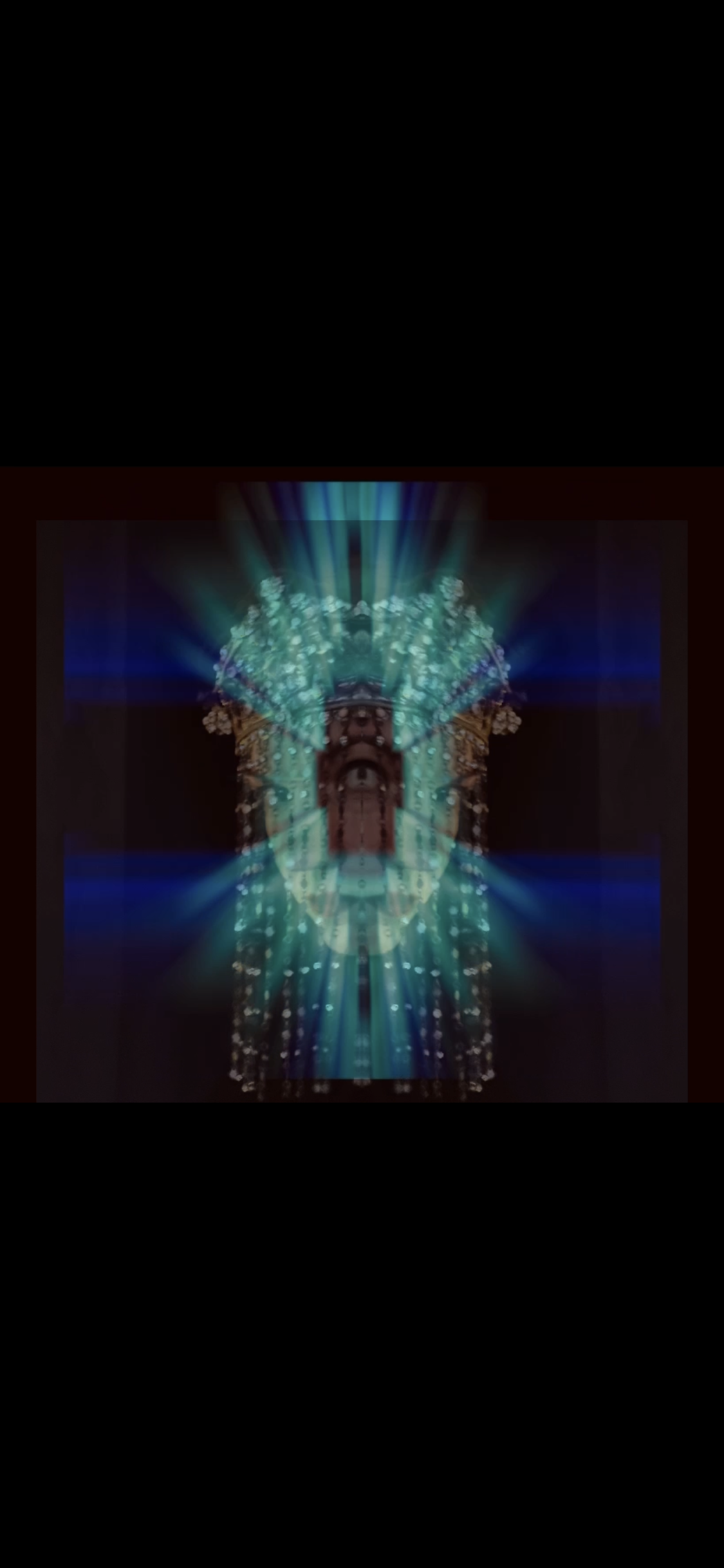 An abstract digital artwork featuring a symmetrical face with a prominent eye at the center, surrounded by vibrant blue and green light rays and intricate patterns on a dark background.