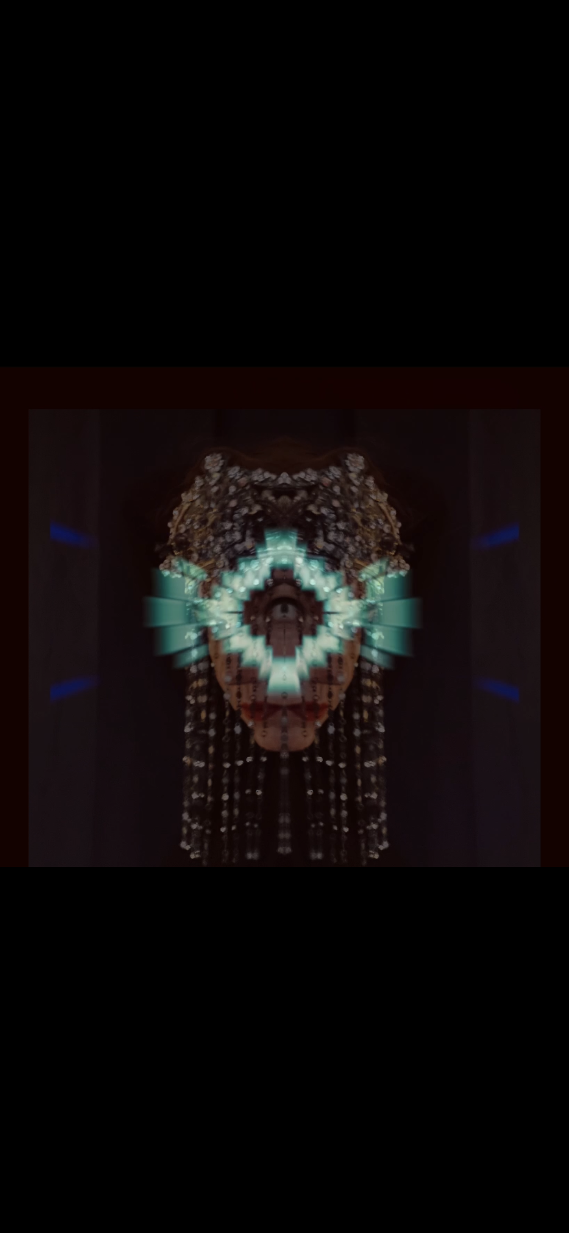 A digital art portrait of a woman with an ornate headpiece and virtual reality goggles, with a symmetrical digital design overlaying her face.