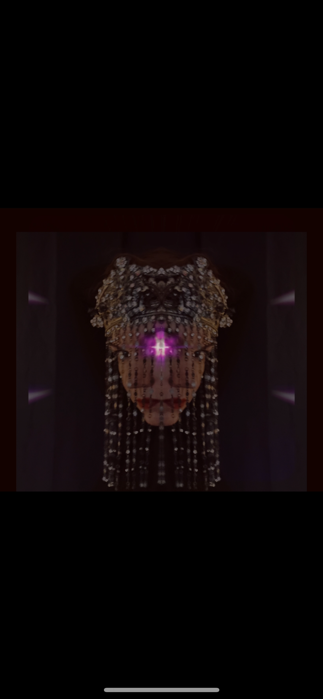 A digital artwork of a person with a face covered in an ornate, beaded mask, with a glowing purple cross on the forehead, and long beaded strands hanging from the mask, set against a dark background.