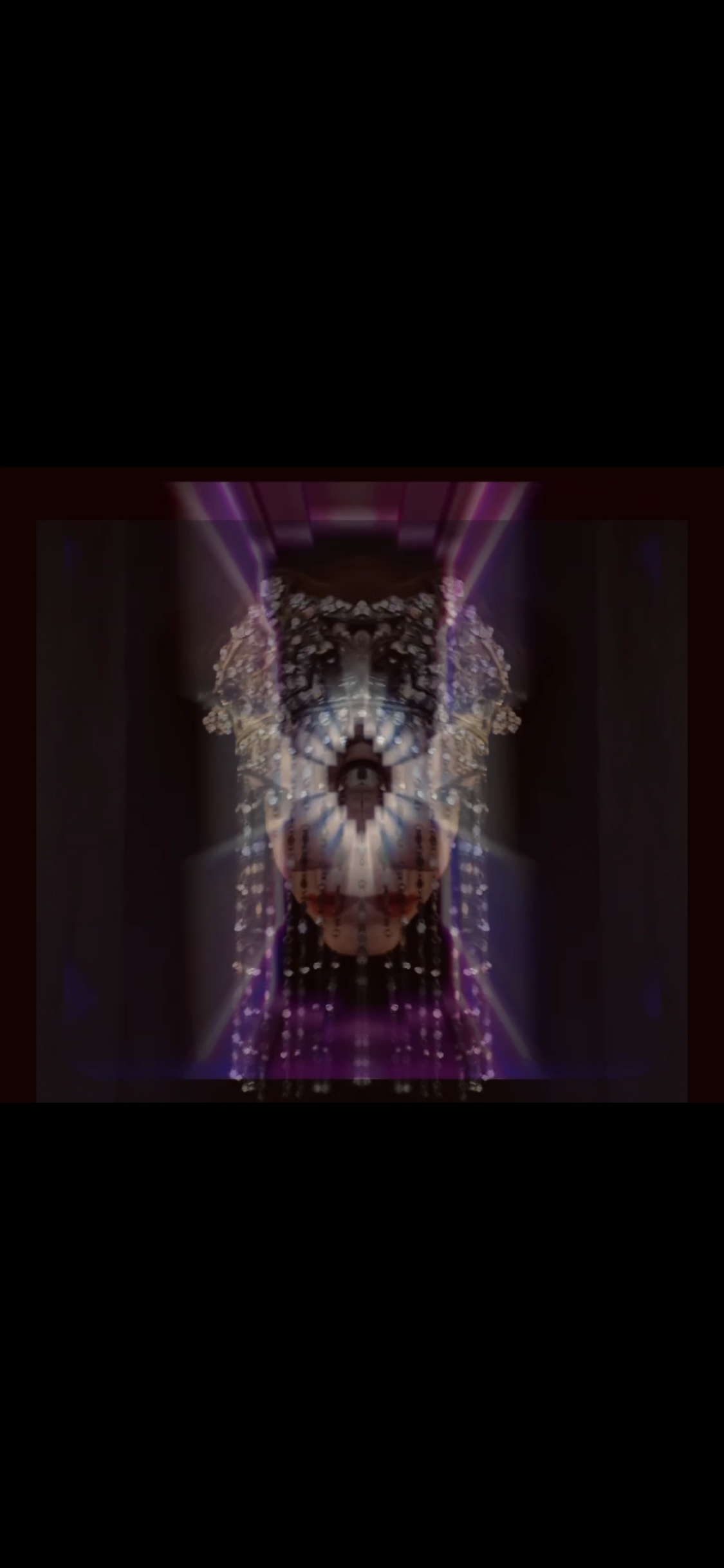Abstract digital artwork with symmetrical patterns and colorful light effects, resembling a butterfly or mask, in vibrant purple, pink, and white tones.