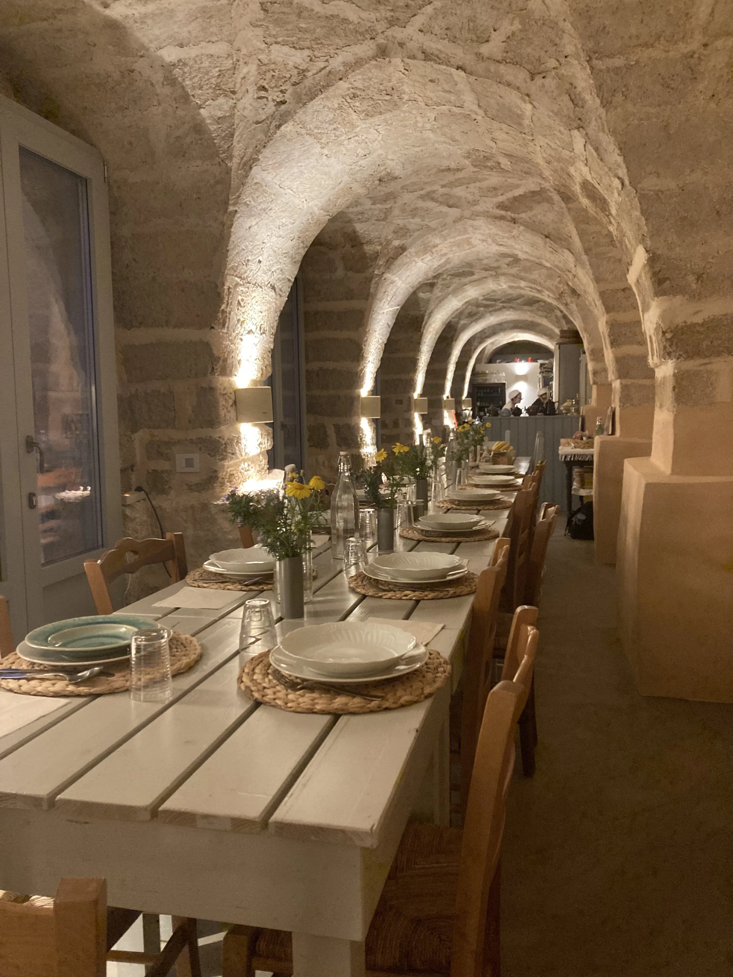 Close-up of natural tableware and elegant rustic details in the dining room at Masseria Specula, reflecting authentic Italian retreat hospitality