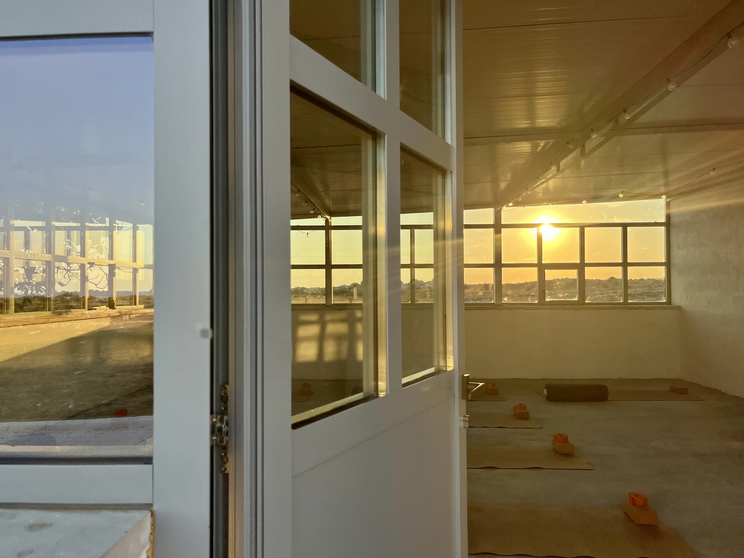 Spacious yoga shala at Masseria Specula with natural light, high ceilings, and a peaceful setting ideal for wellness and yoga retreats in southern Italy