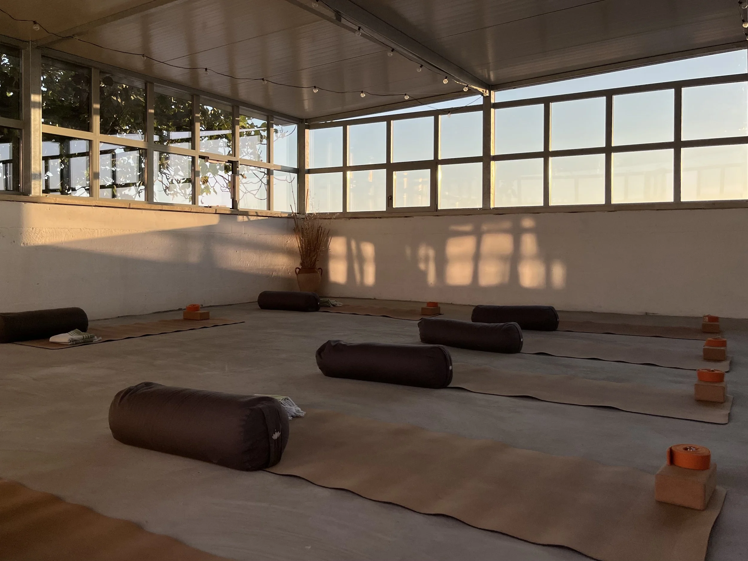Yoga mats and props arranged inside the Masseria Specula yoga shala, prepared for group sessions and immersive retreat experiences in Puglia