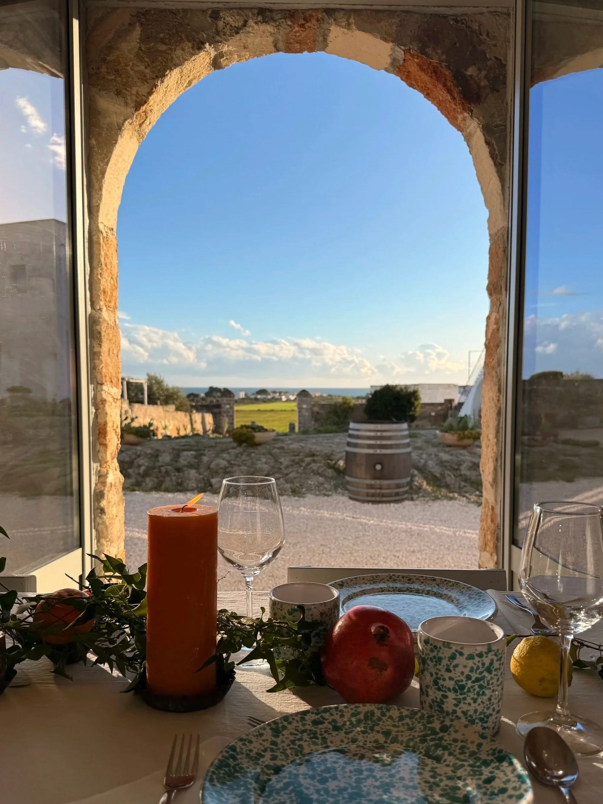 Beautifully set communal dining table at Masseria Specula, ready for shared meals during yoga and wellness retreats in southern Italy