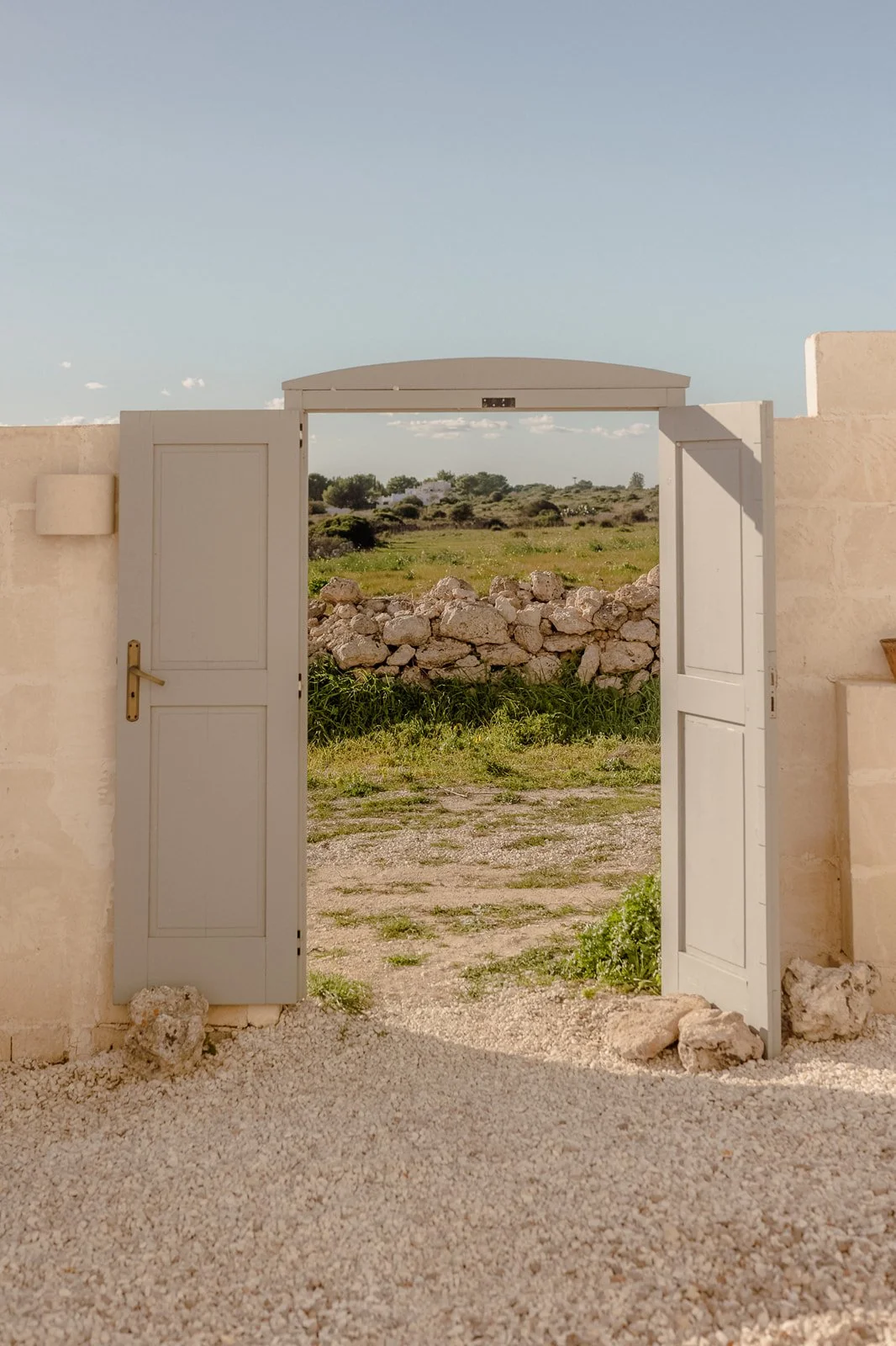 Historic masseria courtyard with gravel ground and olive trees in Puglia, Southern Italy