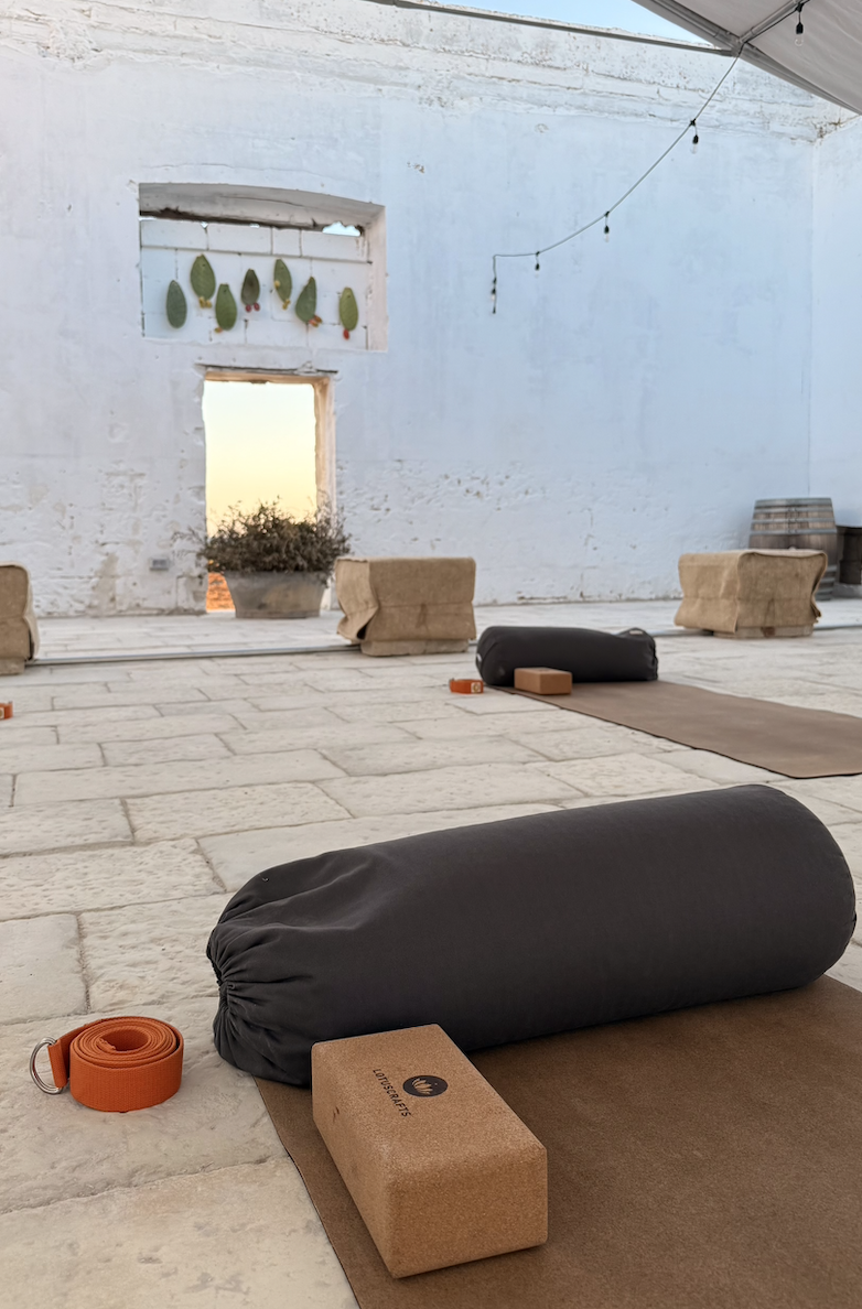 Yoga mats arranged outdoors at Masseria Specula, ready for group practice in a tranquil natural environment in Puglia