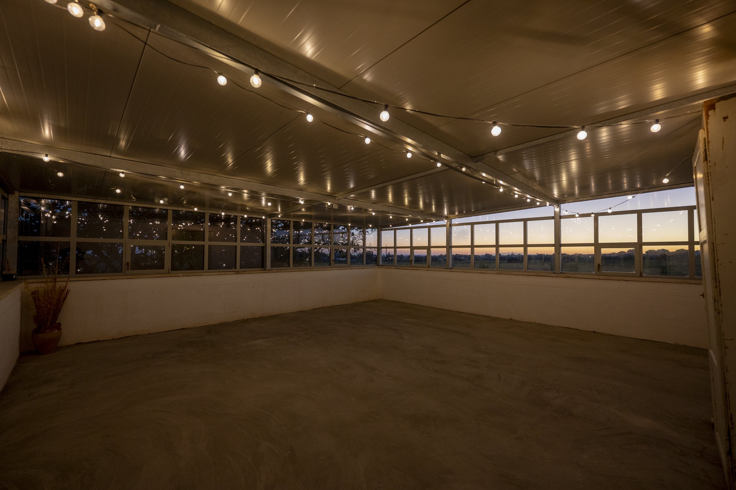 Open and airy yoga shala at Masseria Specula blending indoor comfort with outdoor nature, creating a calming environment for yoga retreats in Italy