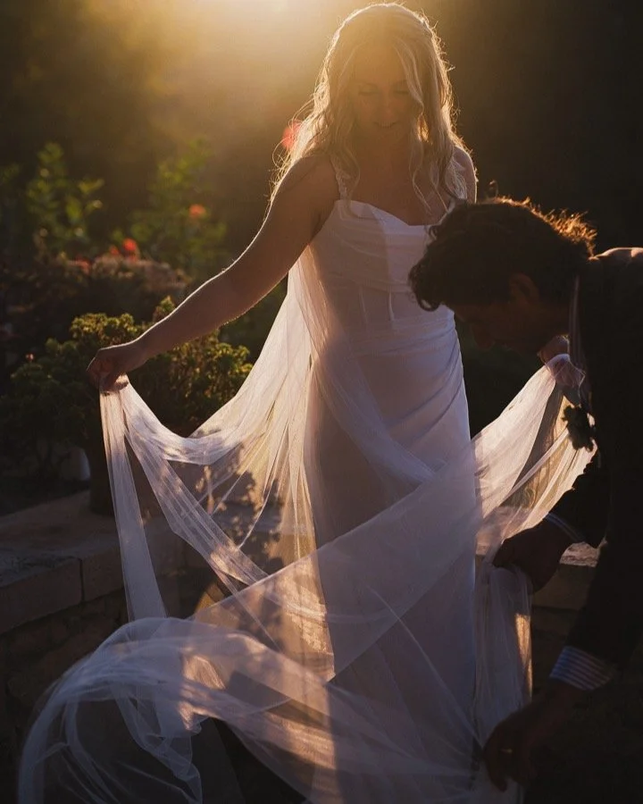 Illumination - love little scenes like this. Completely unposed, just rearranging the dress. But oh that backlight is everything. Click. Finding beauty in the spaces, in the small moments. #documentaryweddingphotography #weddingphotojournalism #crete