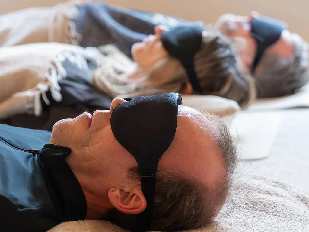 Group of people experiencing a sound bath meditation for stress relief in New York City with Recalibrate Mind Body.