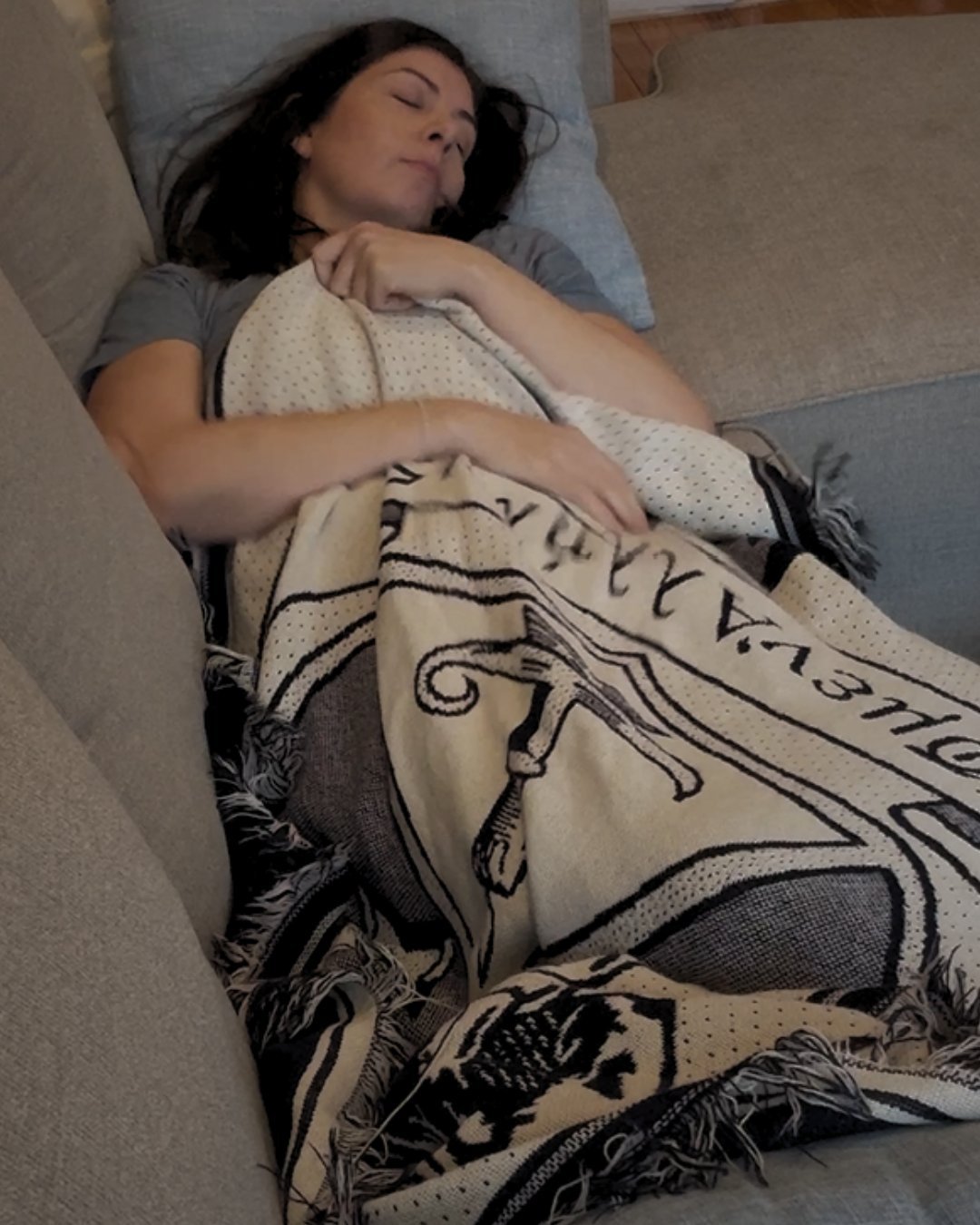 Katie Boysen relaxing under a blanket during an at-home sound bath