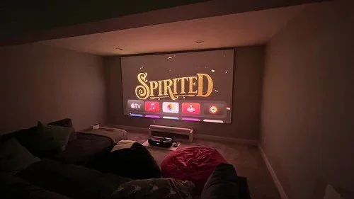 Home theater room with a projector screen and dimmed lighting, Springfield OH home theater installation