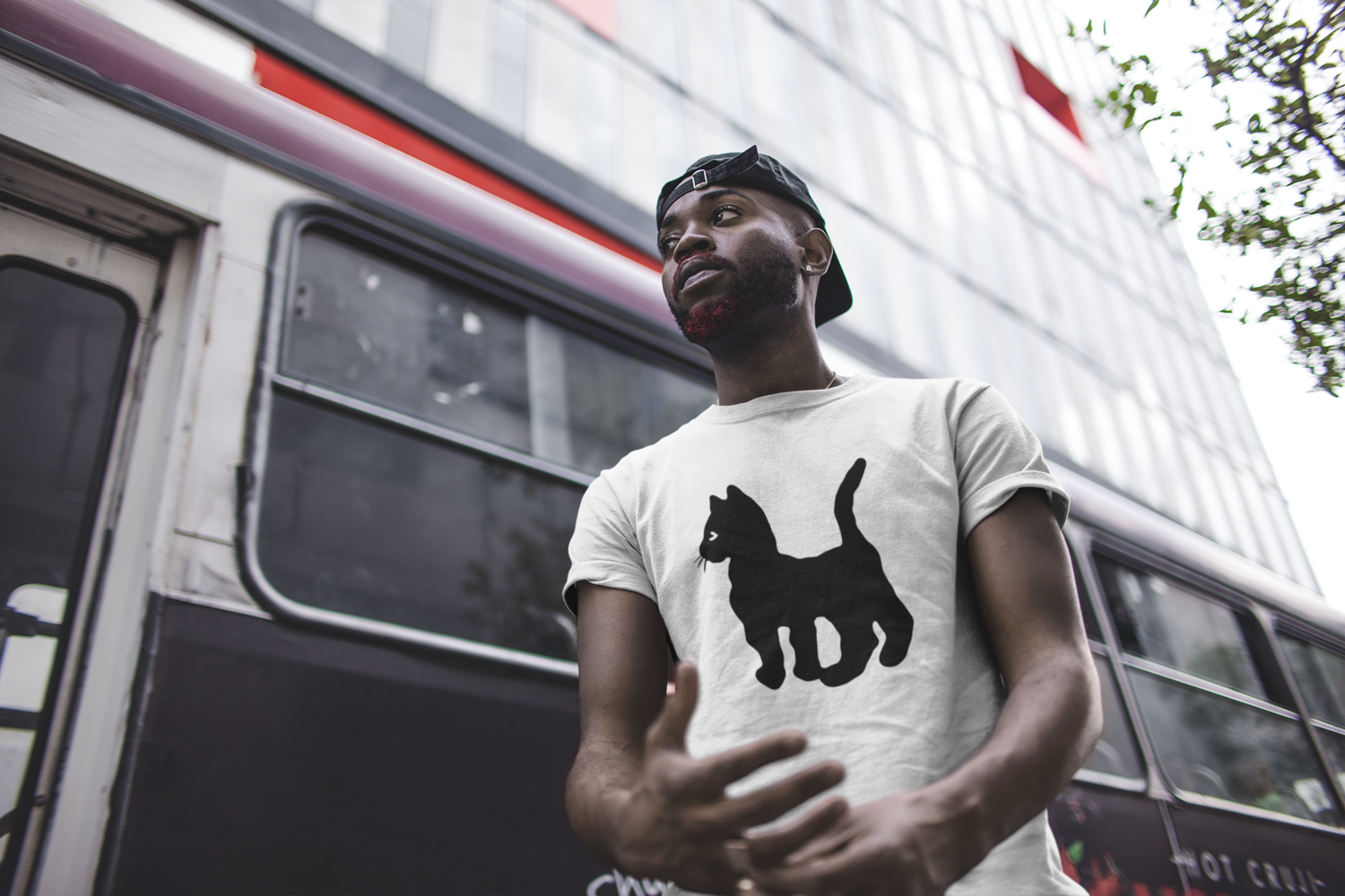 mockup-of-a-man-wearing-a-tee-in-front-of-a-city-bus-21680.png