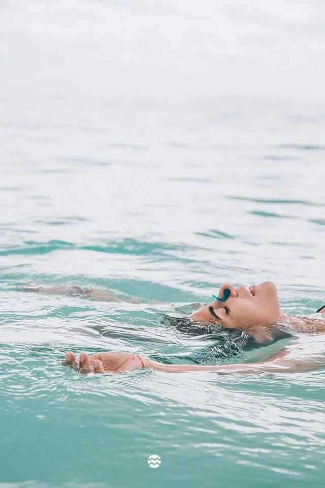 Janzu Water Treatment in the Caribbean in Tulum. MX. Guest floating weightlessly in the embrace of the ocean.