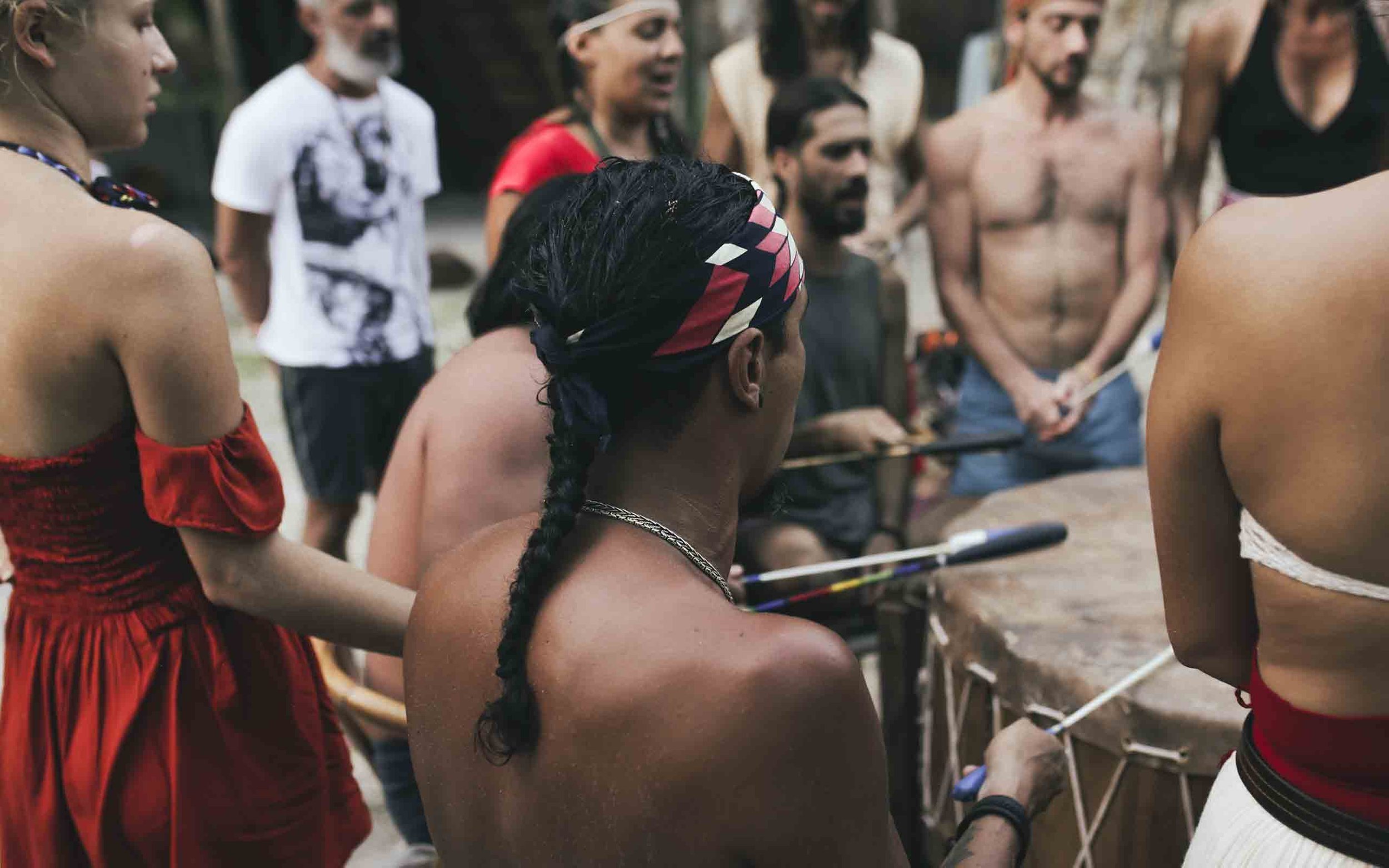 Community opening for a beachfront temazcal at Medicine Wheel Tulum. Guests and practitioners gather with sacred drums and music where the jungle meets the sea.