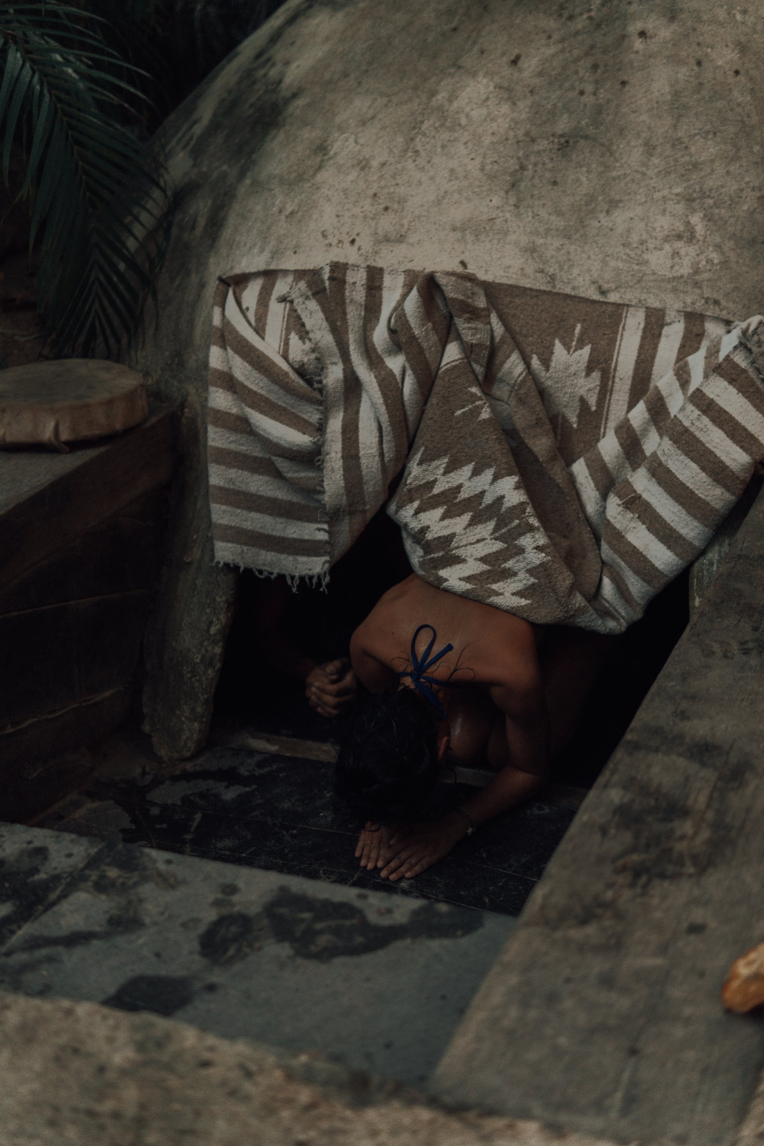 A guest practicing gratitude after a traditional temazcal at Medicine Wheel Tulum. Experience spiritual renewal in our cozy jungle sanctuary.