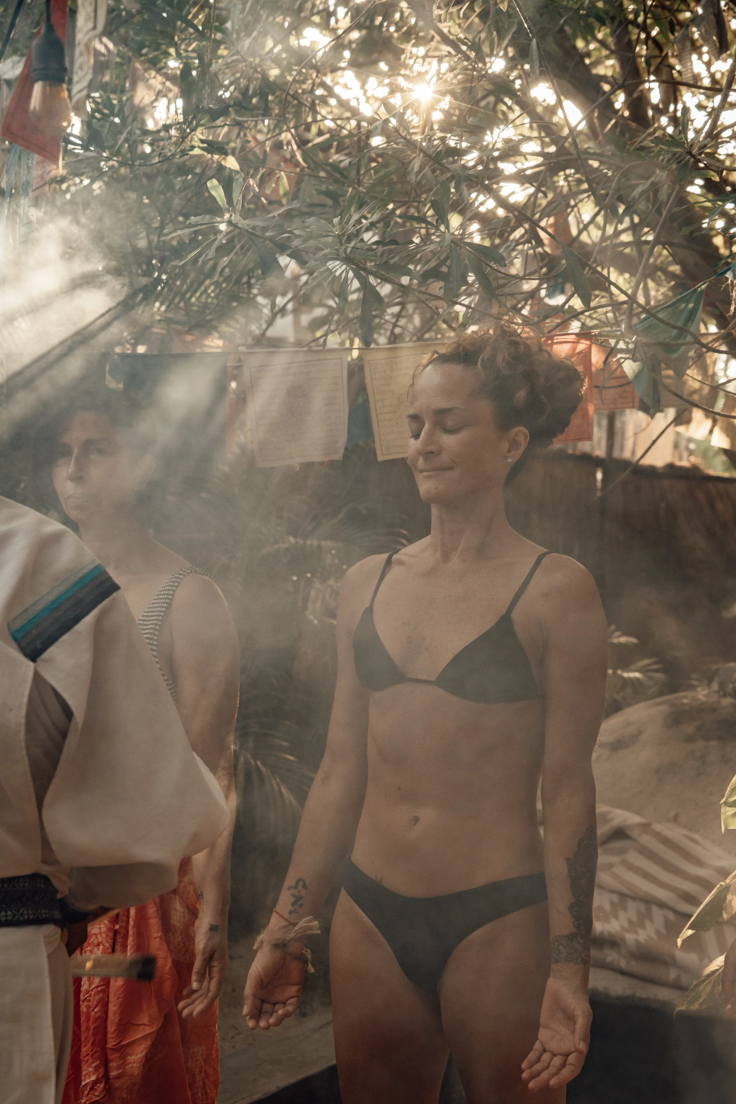Spiritual cleansing ceremony at Medicine Wheel Tulum. A woman experiences a traditional smoke ritual and jungle rebirth in our authentic temazcal sanctuary.