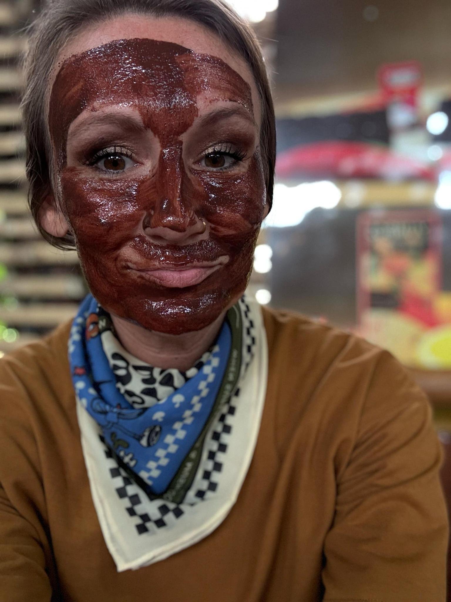Woman with medicinal cacao face mask from a chocolate tour in Mindo, Ecuador