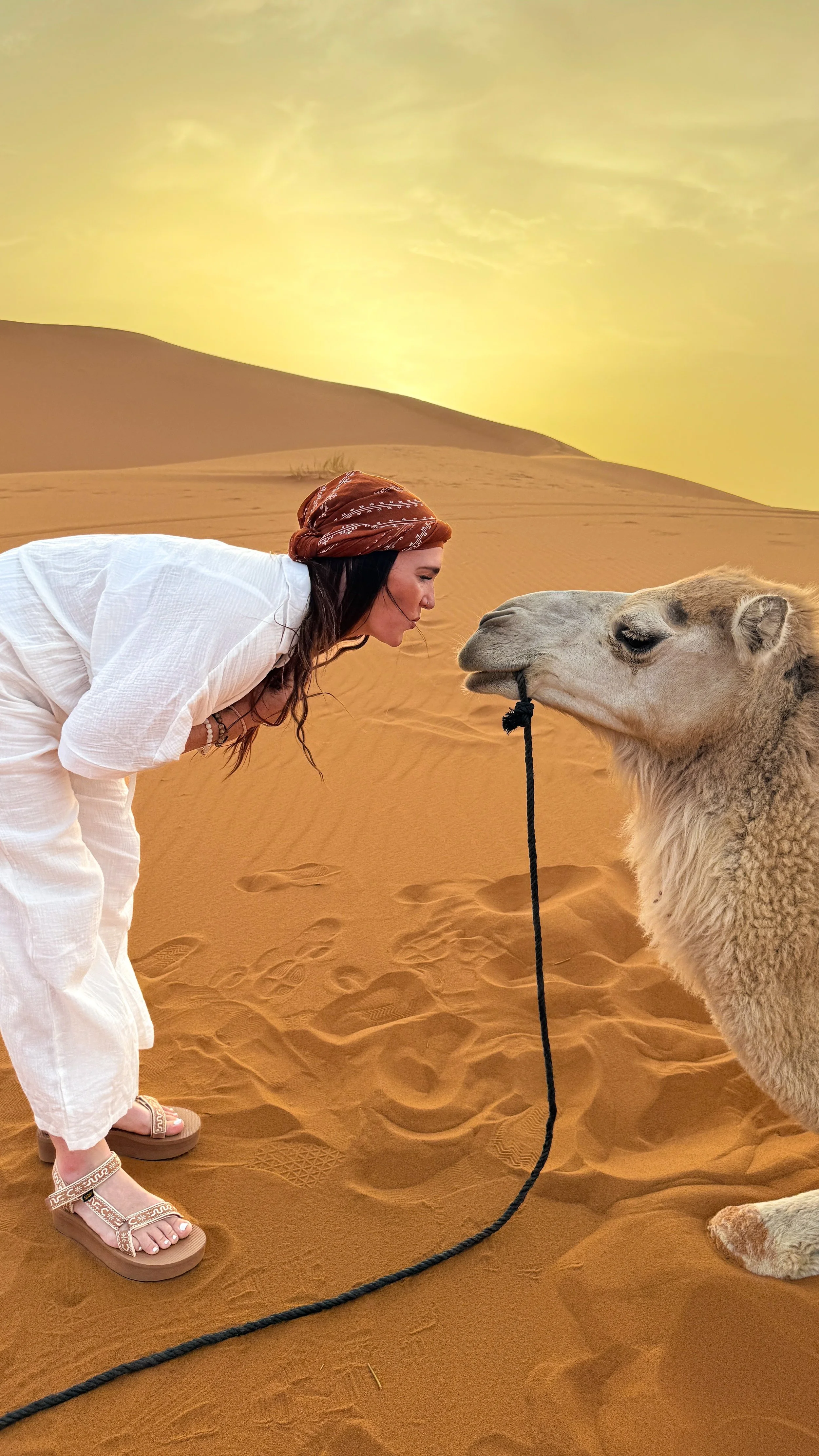 Laura Ericson face to face with a camel in the Sahara Desert