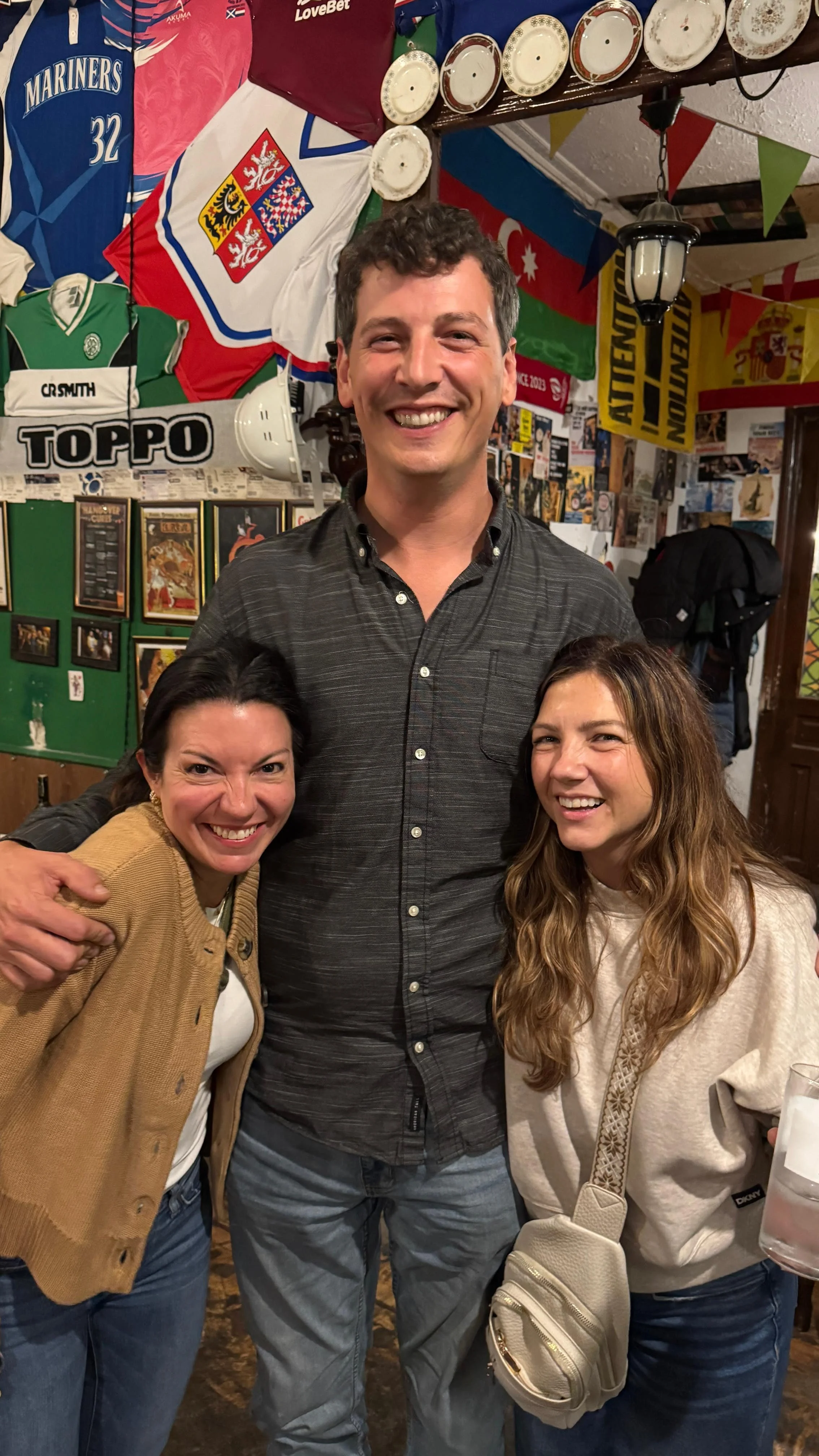 Male traveler Erik with female group members at Georgian restaurant, mixed-gender group trip