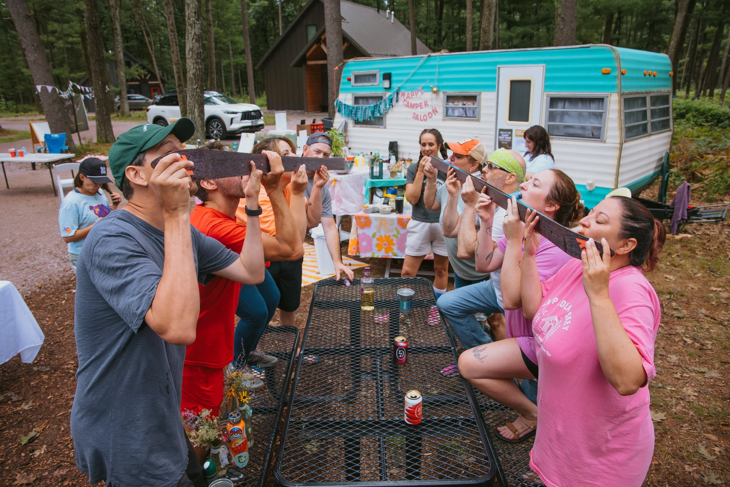 A group doing a shot-ski at Camp Lola Whiskey