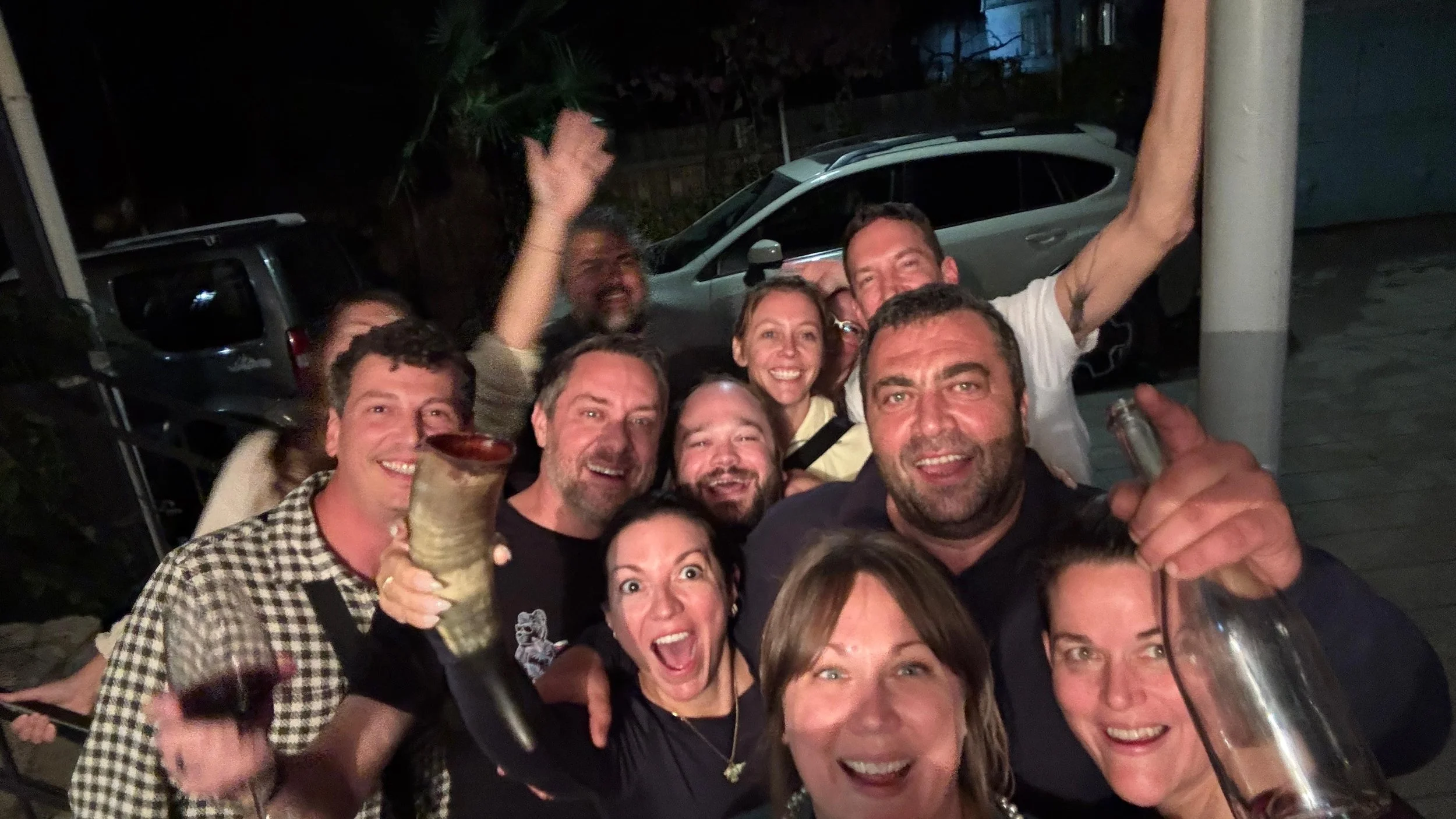 Happy travel group celebrating at night in Georgia, Laura Ericson Group Trips adventure