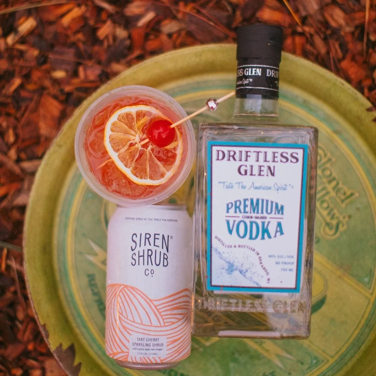 Campfire Cherry Fizz cocktail made with Driftless Glen vodka and Siren Shrub tart cherry sparkling shrub with orange slice garnish