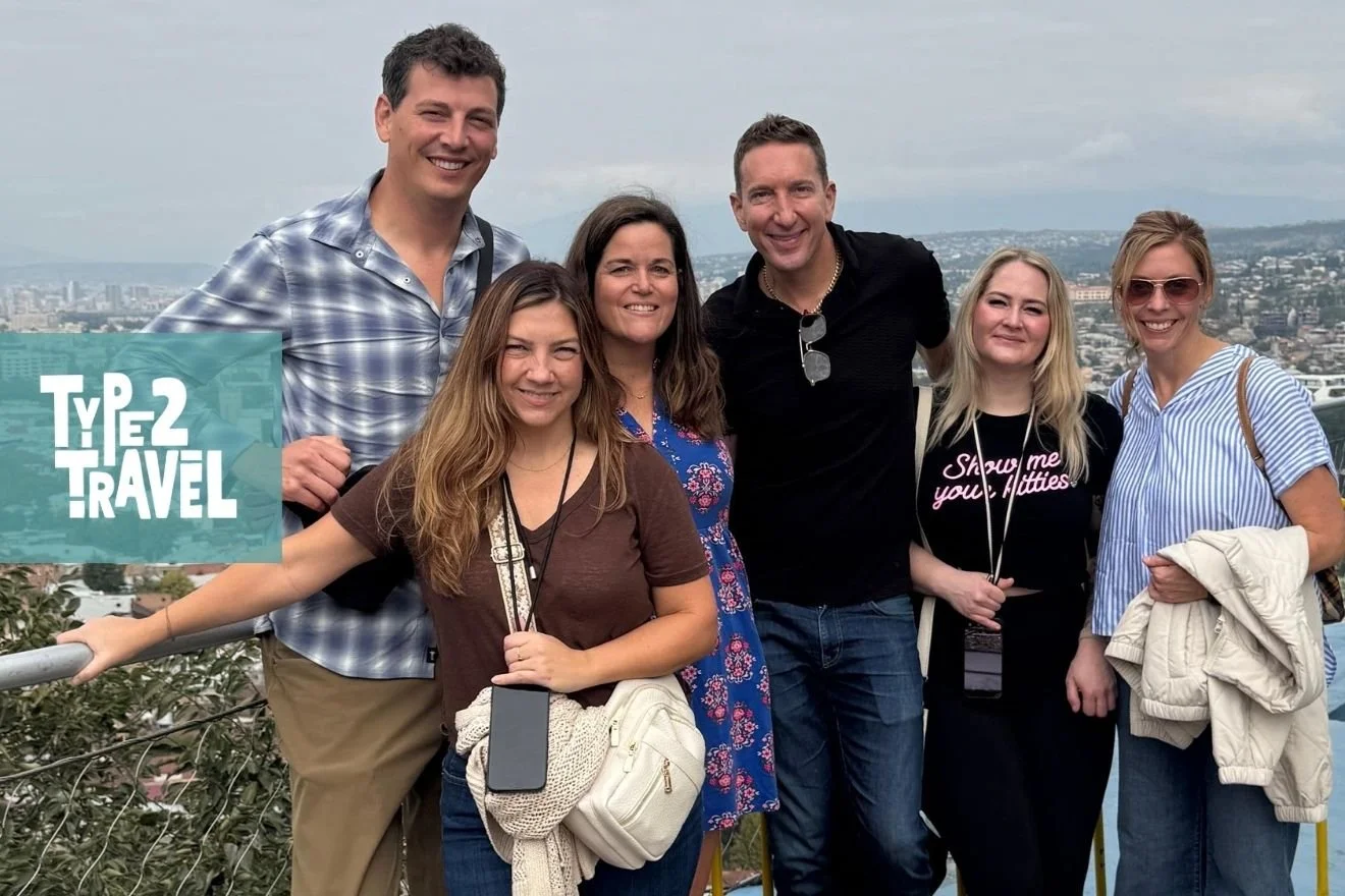 Type 2 Travel podcast group photo overlooking Tbilisi Georgia cityscape and Black Sea with travelers from Georgia trip episode
