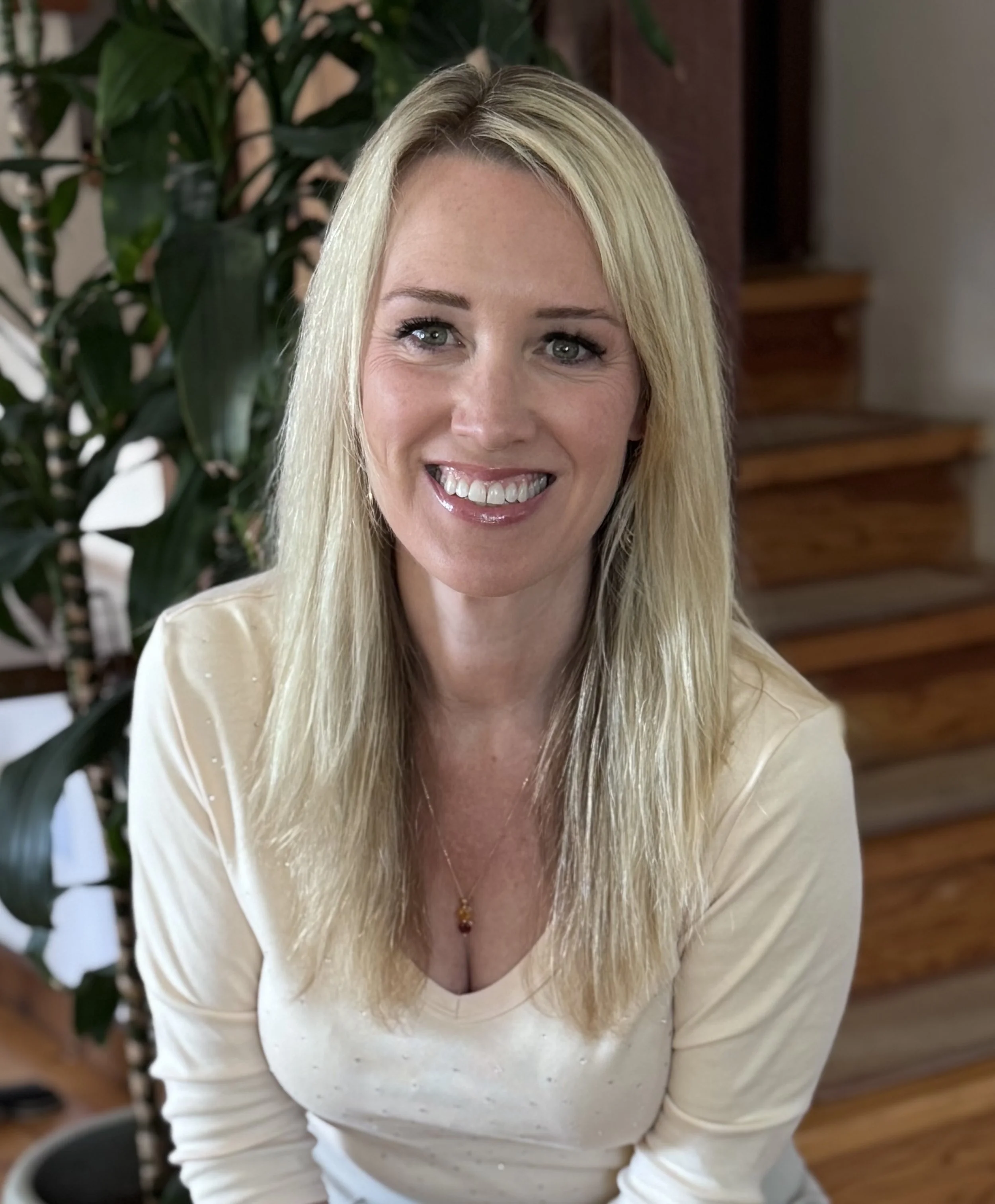 Professional headshot of Sara Margulis, blonde woman in cream top smiling warmly at camera, CEO and co-founder of Honeyfund
