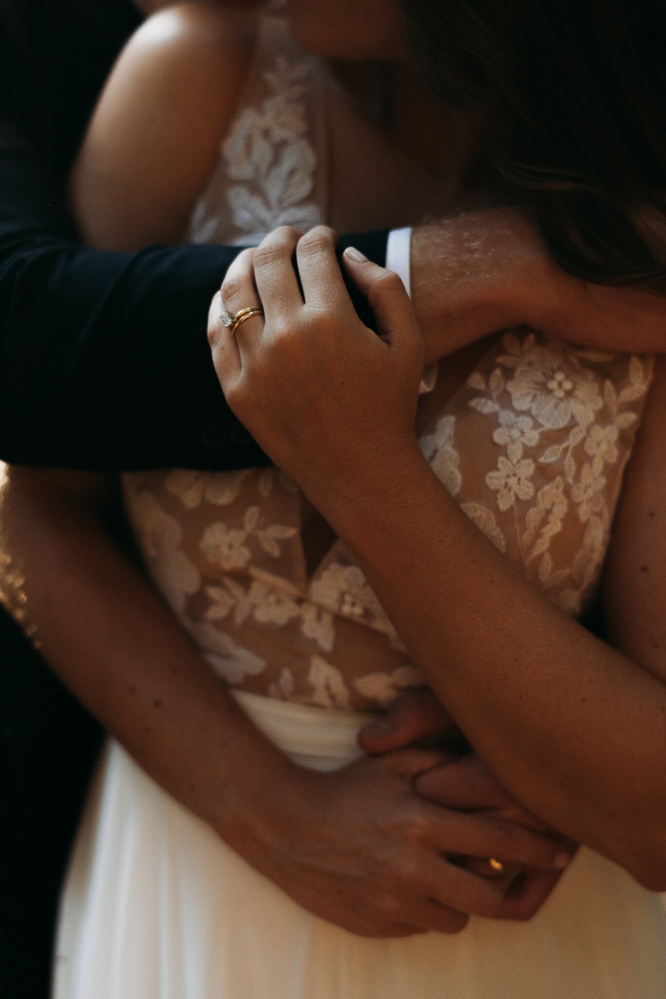 close up of bride chest with grooms arm around her she is holding his arms Big Sur Elopement day!
