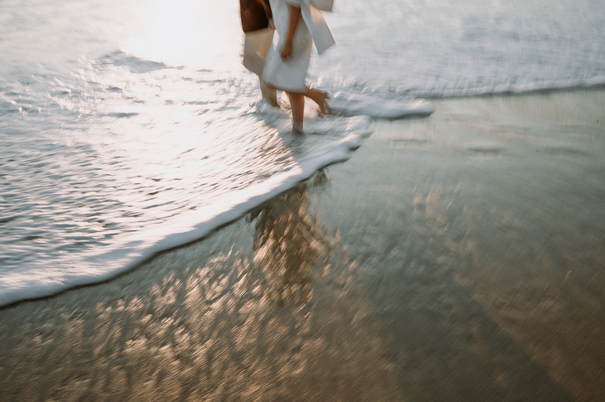 Couple-walking-in-waves-Big-Sur-Garrapata-beach-engagement