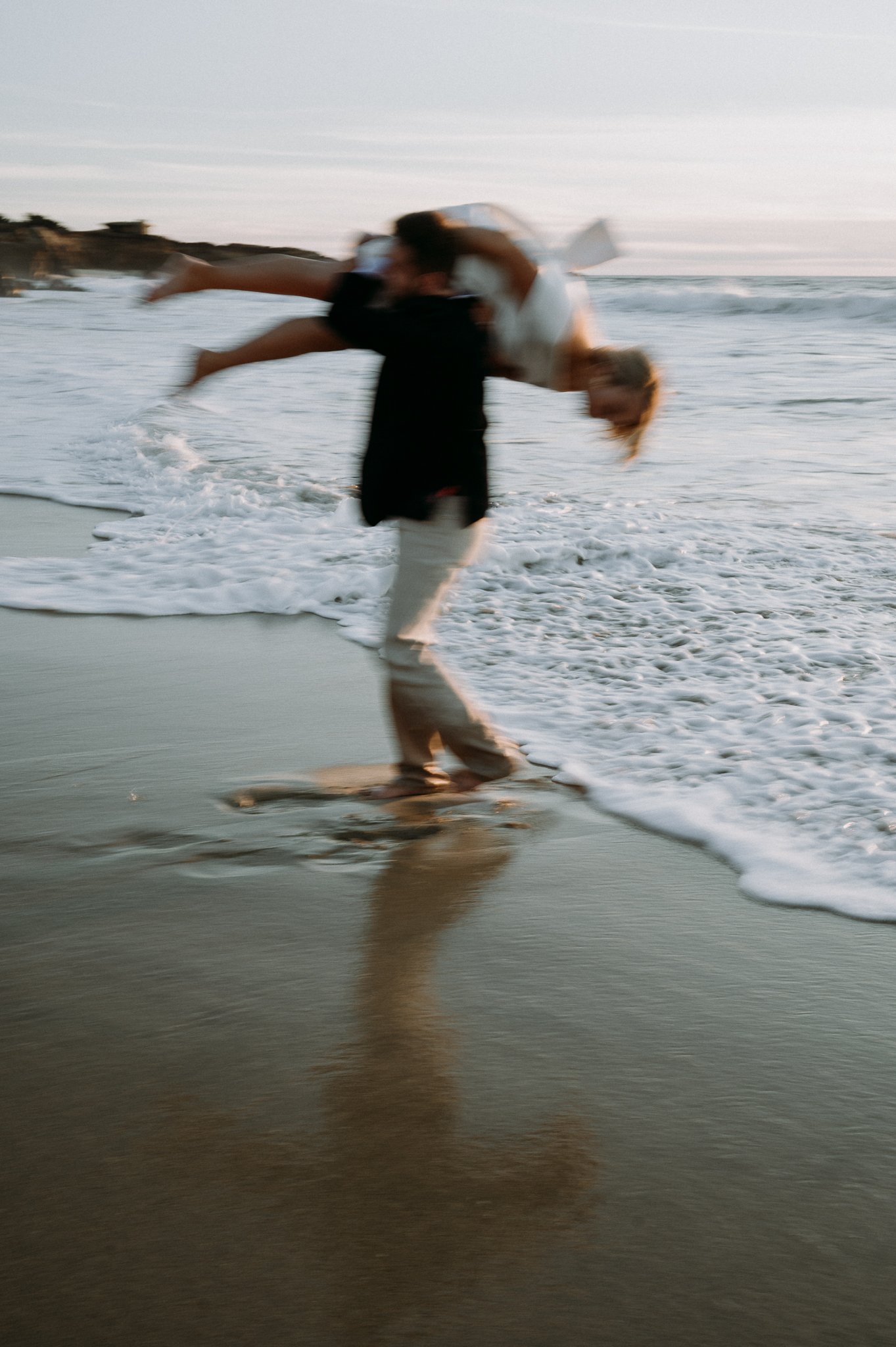 Couple-playing-in-waves-Big-Sur-Garrapata-beach-engagement