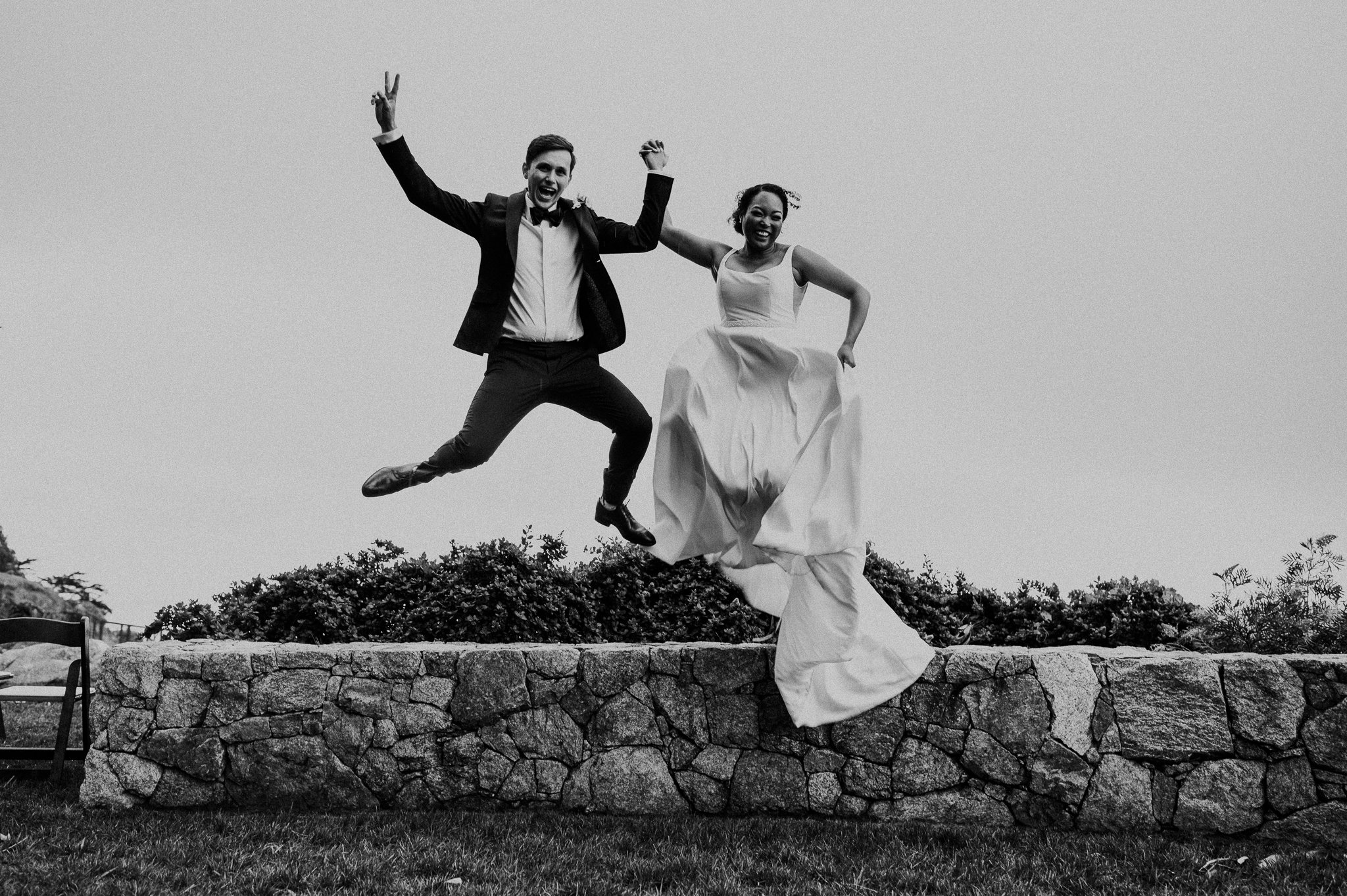 Wind-and-Sea-Wedding-bride-groom-jumping-overlooking-Pacific-Ocean